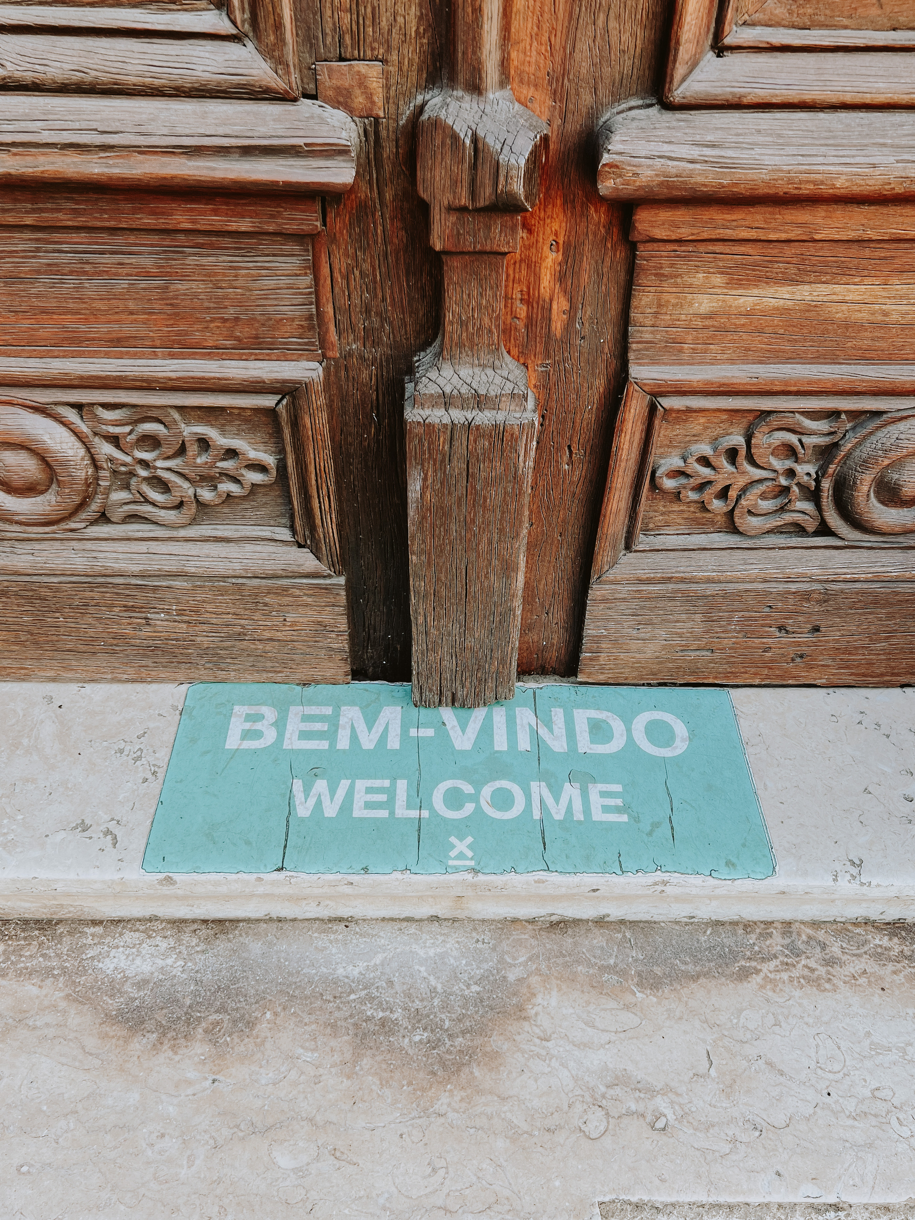 a welcome sign next to a door