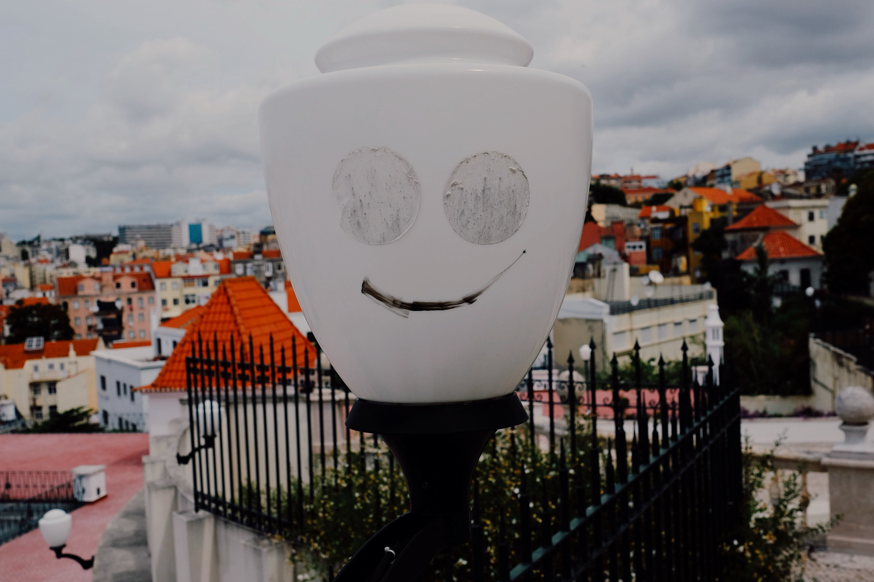 A street lamp with eyes and a smiling mouth.