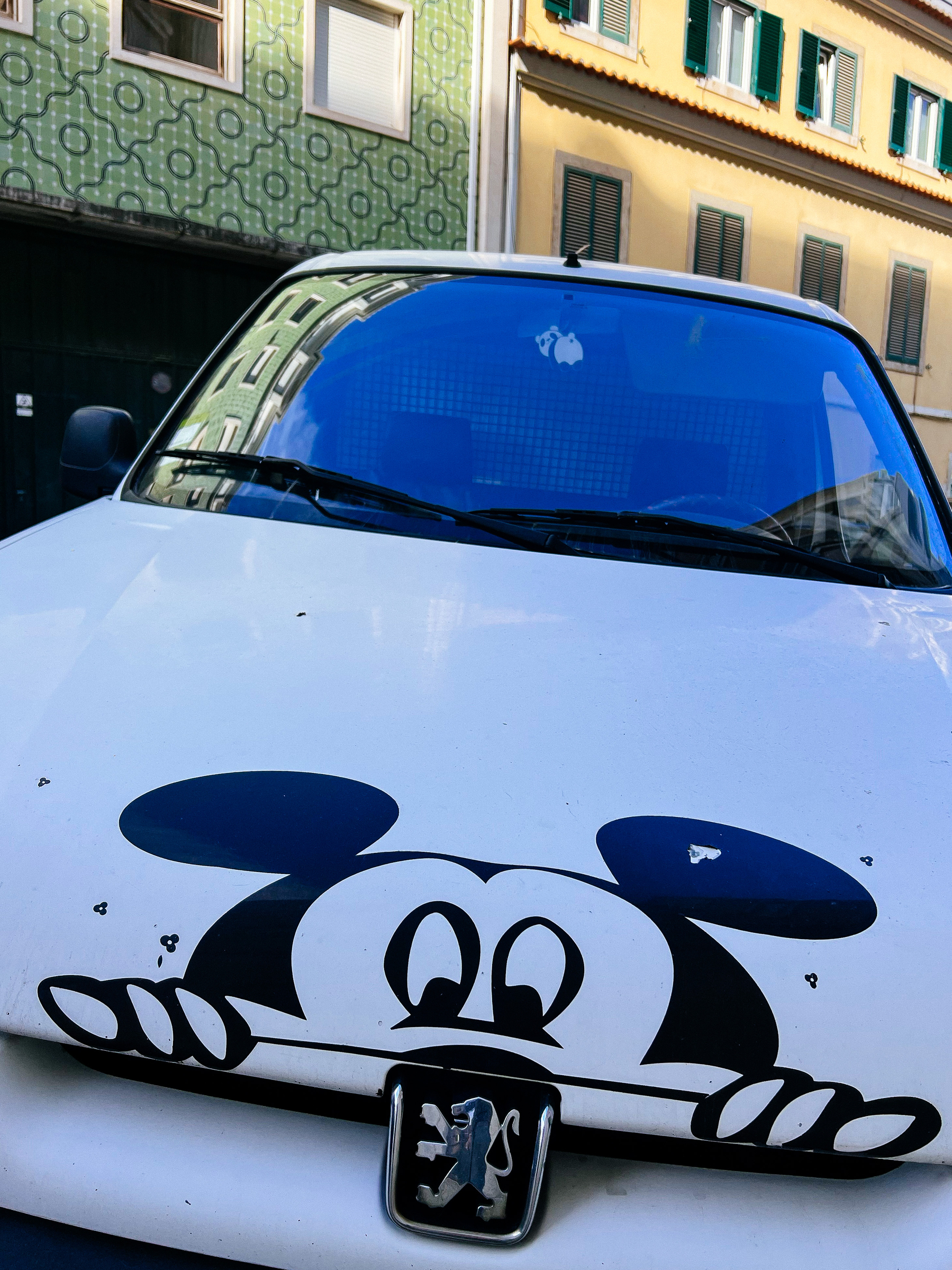 Mickey Mouse drawn on a Peugeot hood. 
