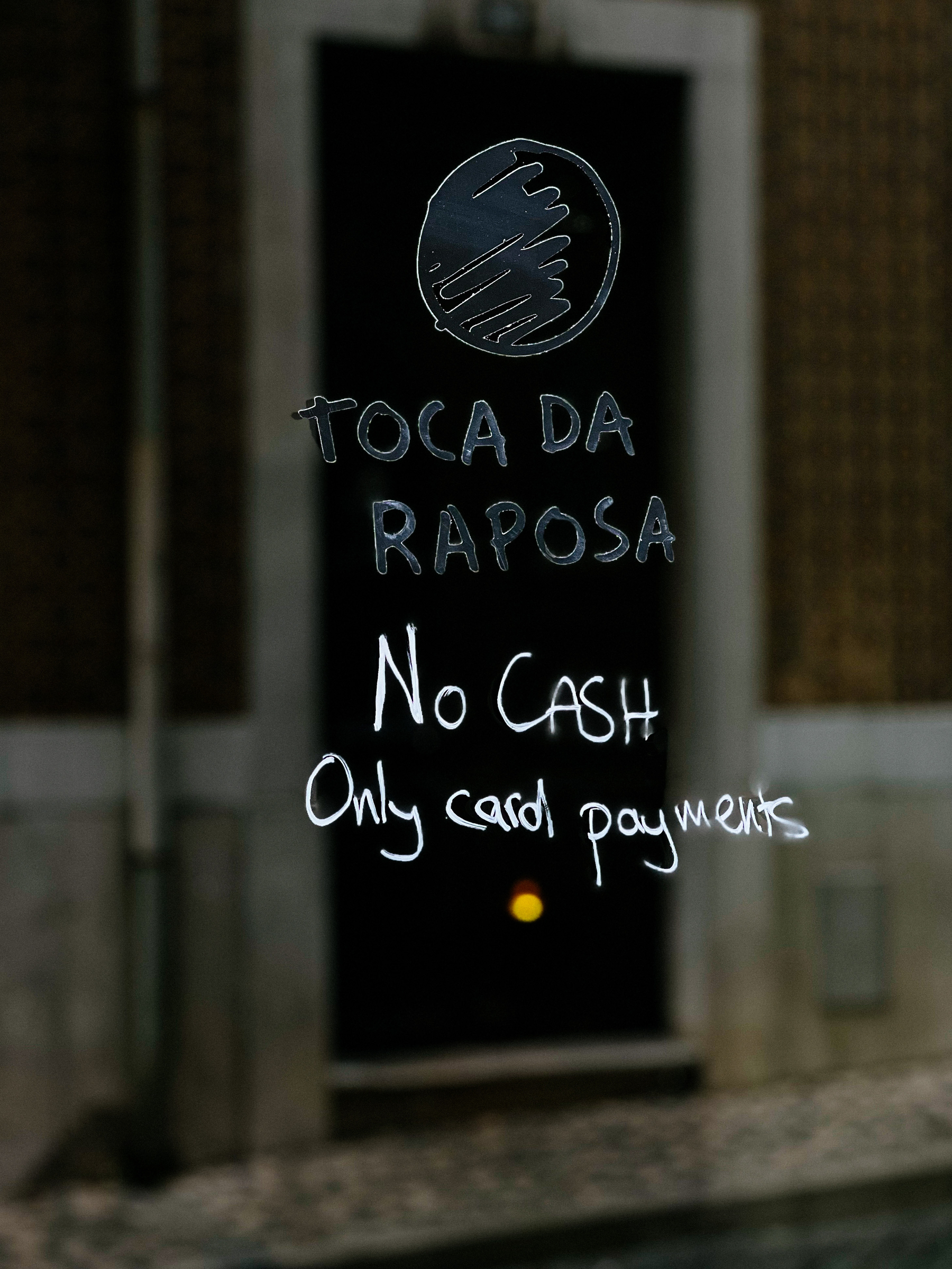 A shop window, with a “no cash, only card payments” warning. 