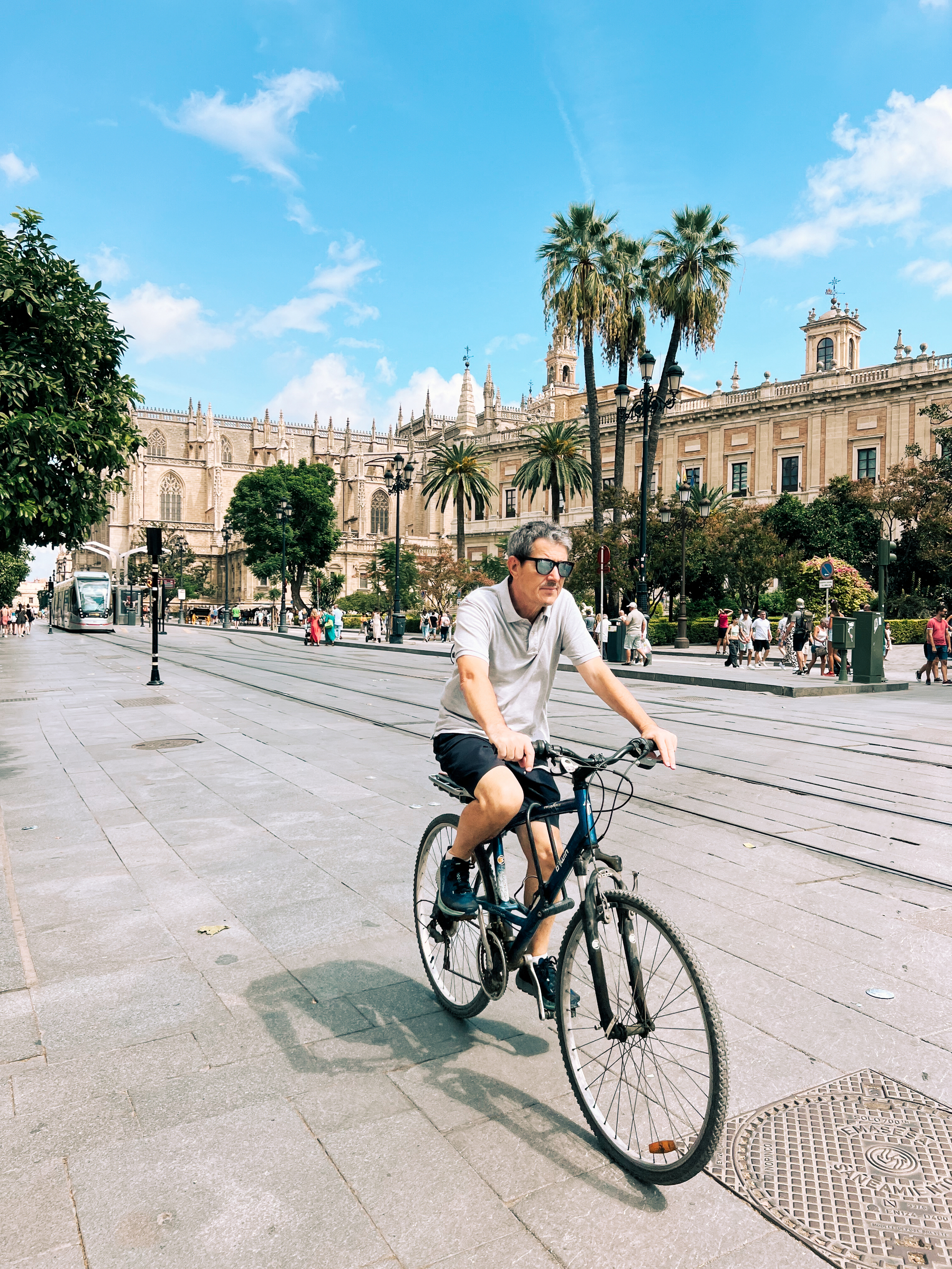 A man rides his bicycle past Seville&rsquo;s cathedral.