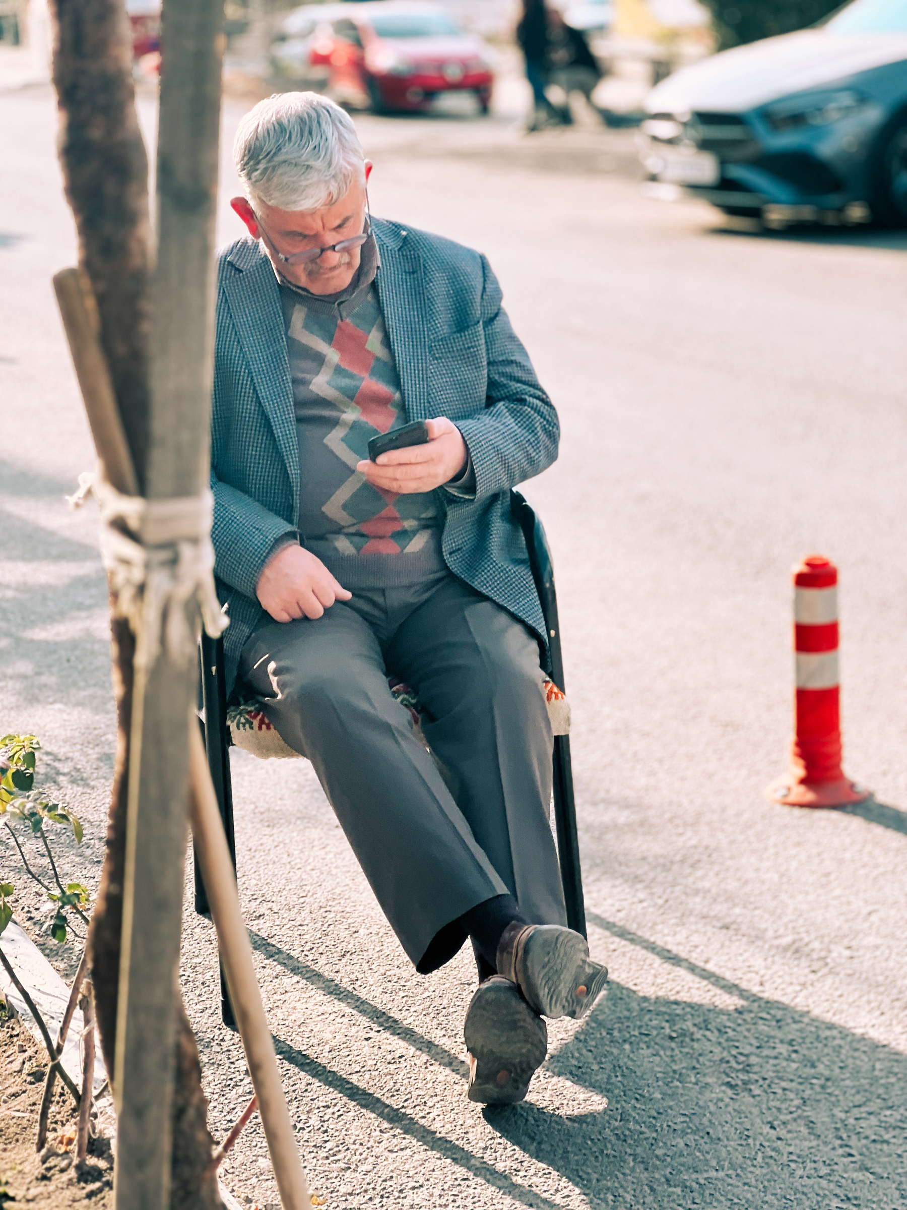 Old man checks his smartphone.