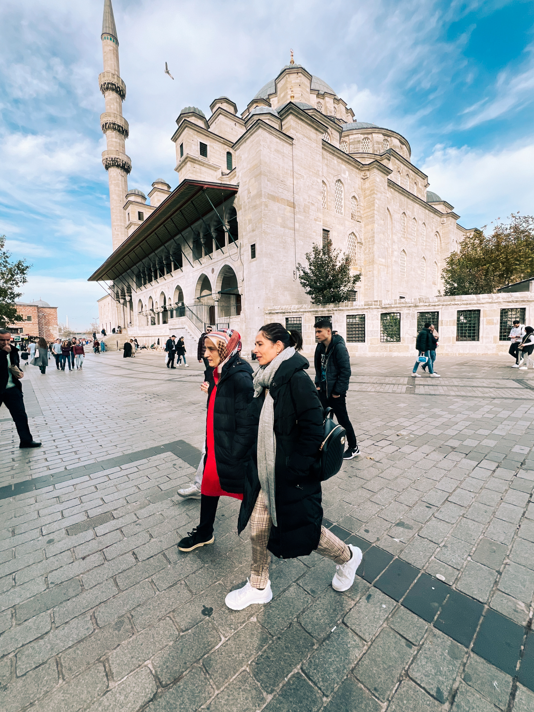 People walk by a mosque. 