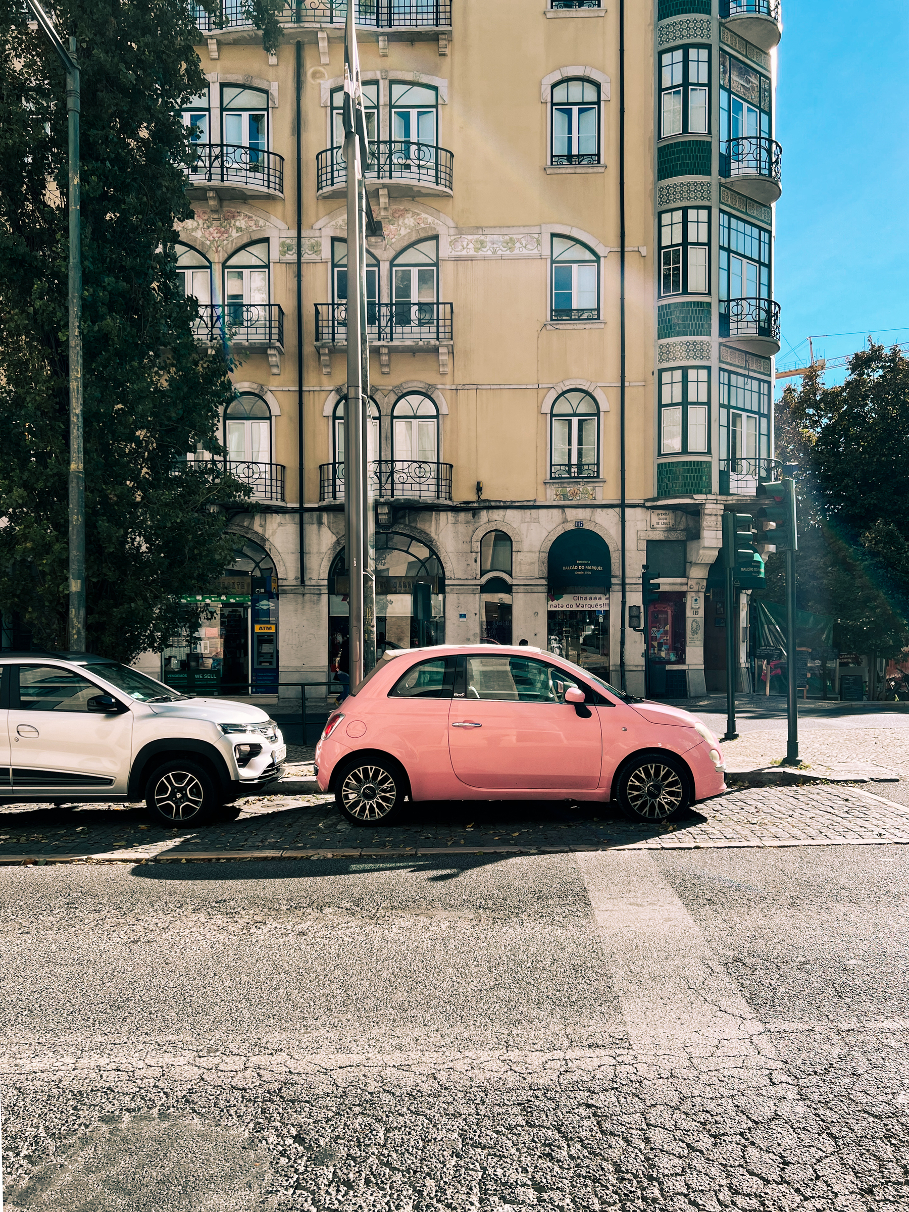 A parked pink car.