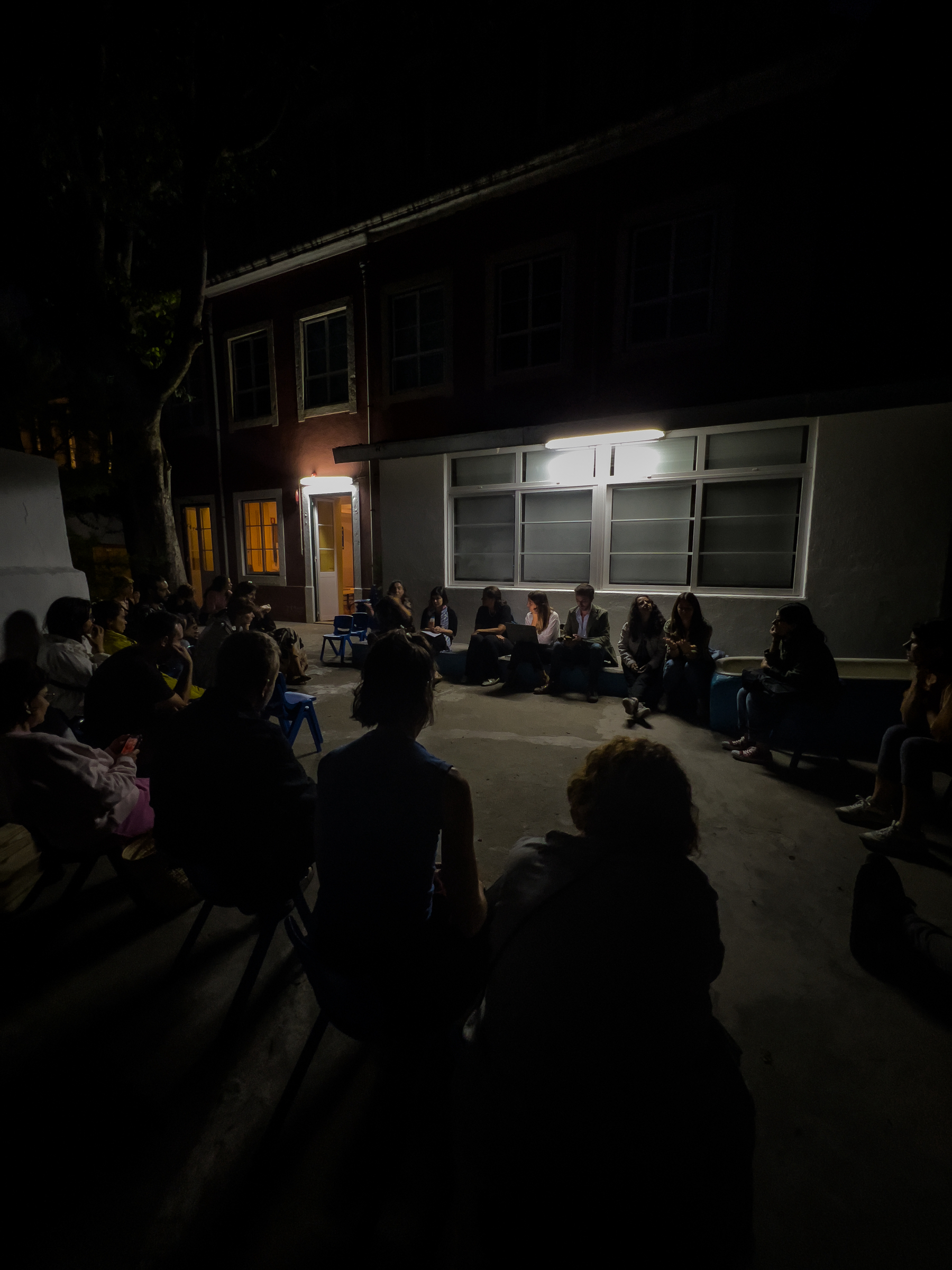 People sitting in the dark, meeting. 