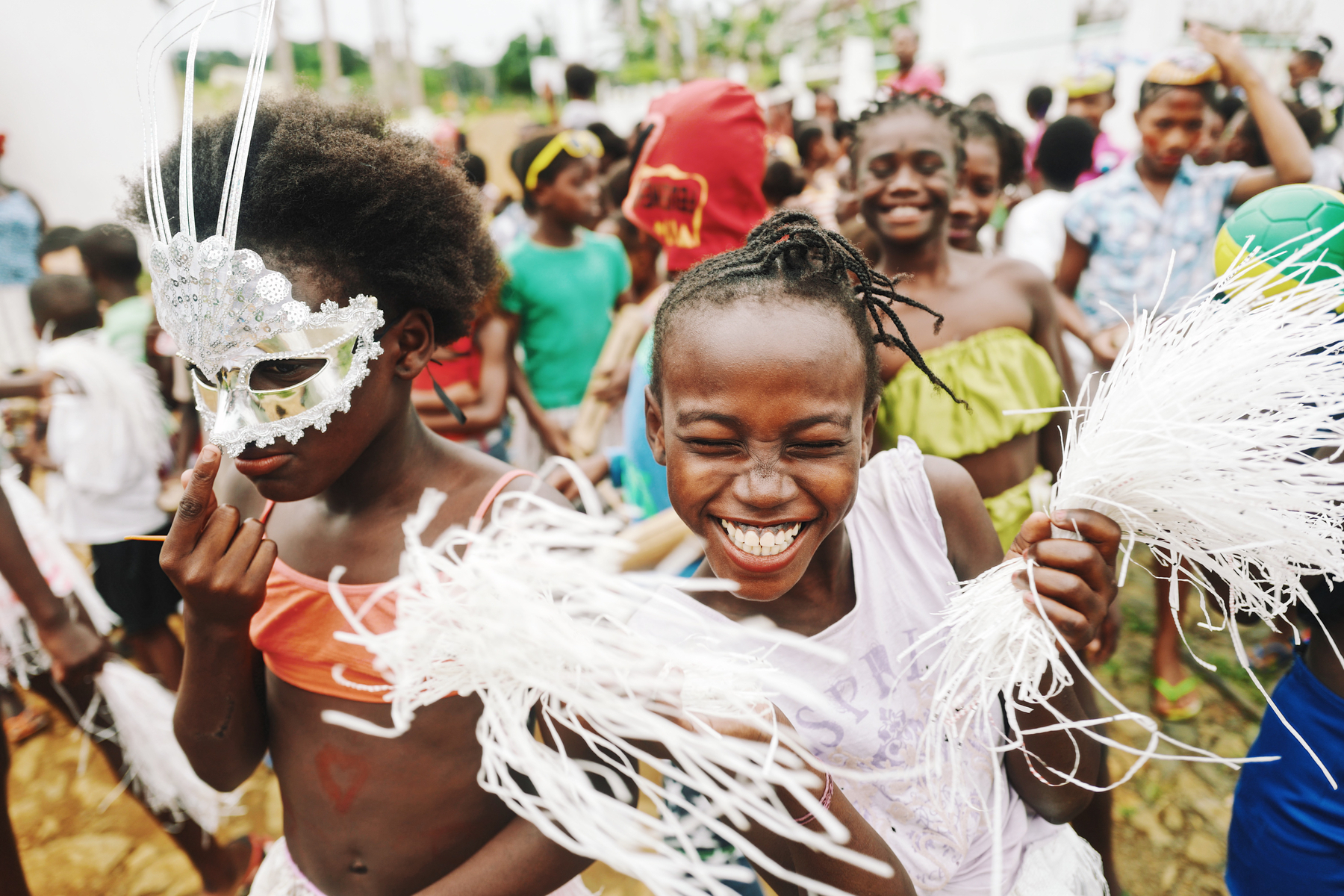 Kids, some wearing masks, have fun during Carnival. 