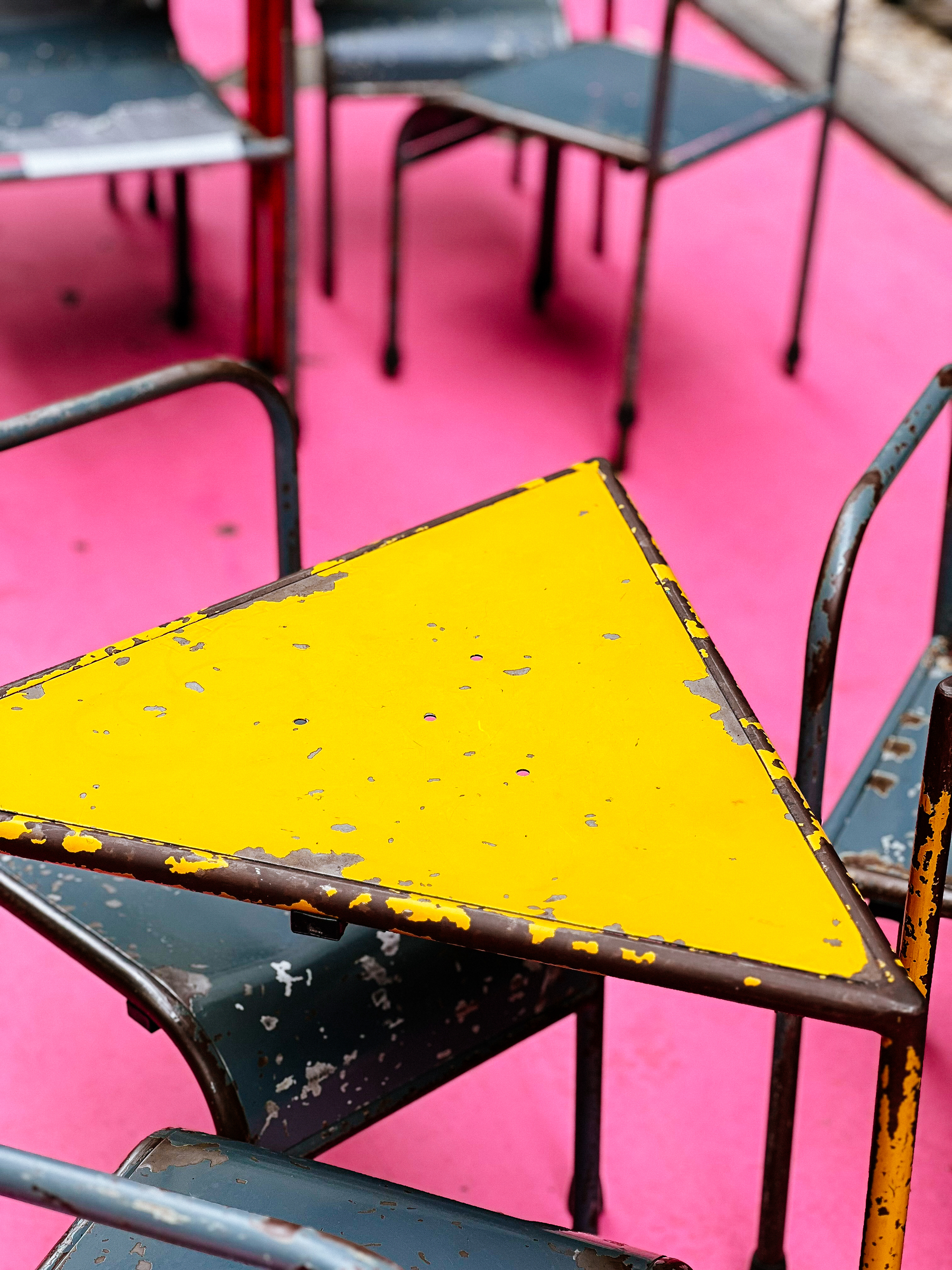 A yellow metal table, and chairs.