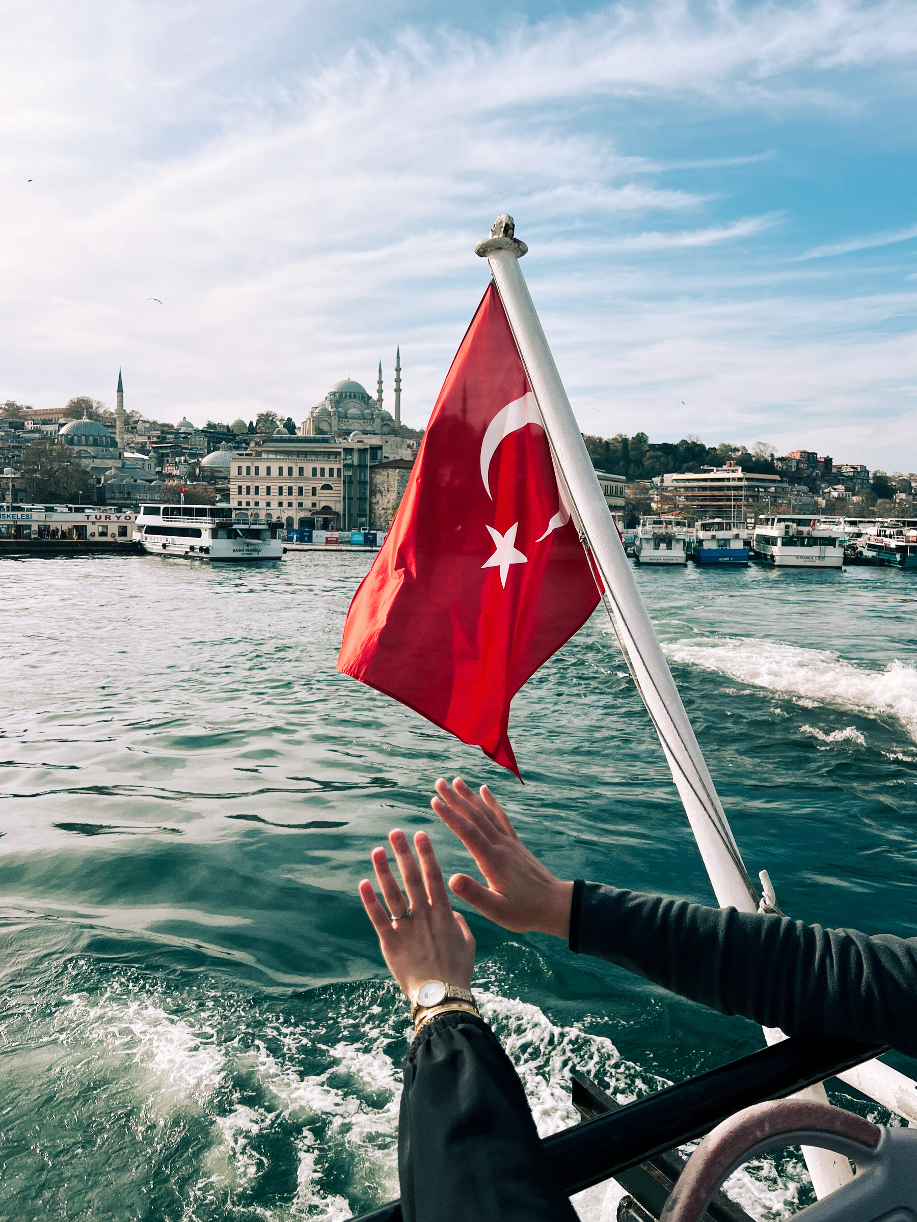 Two hands, a Turkish flag, and the river. 