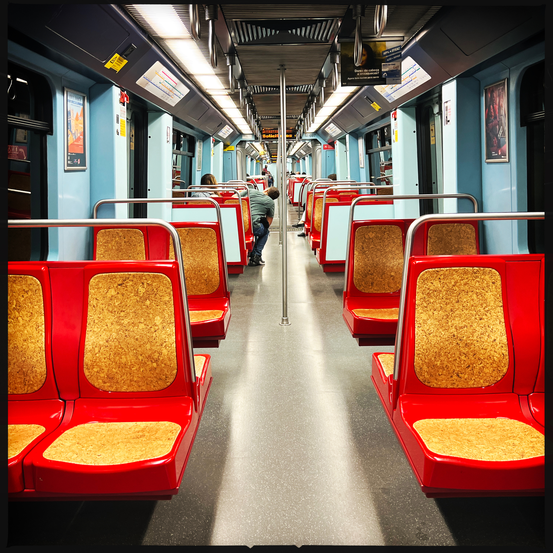 inside of a metro train, with red seats.
