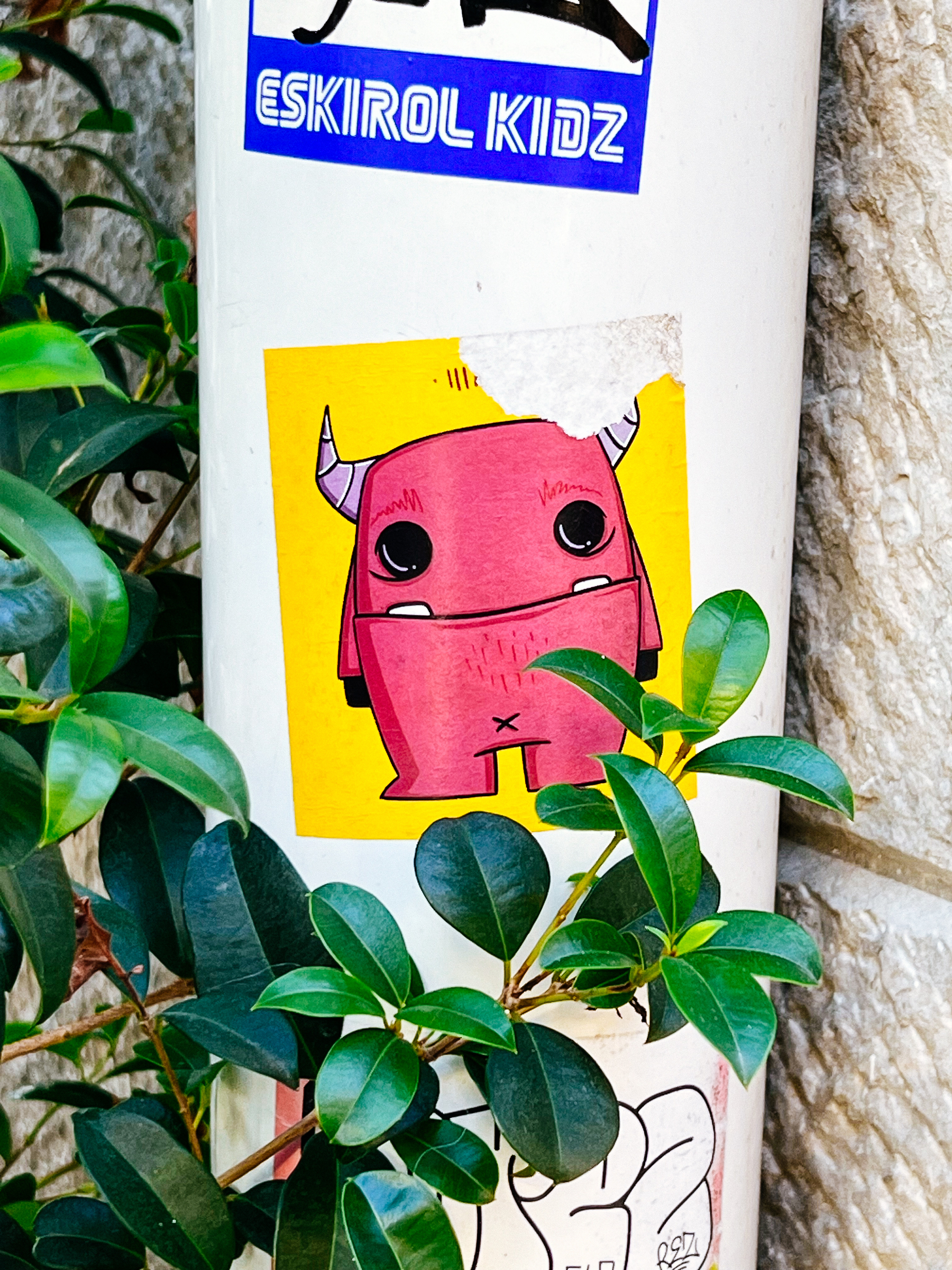 A cute pink monster in a sticker.
