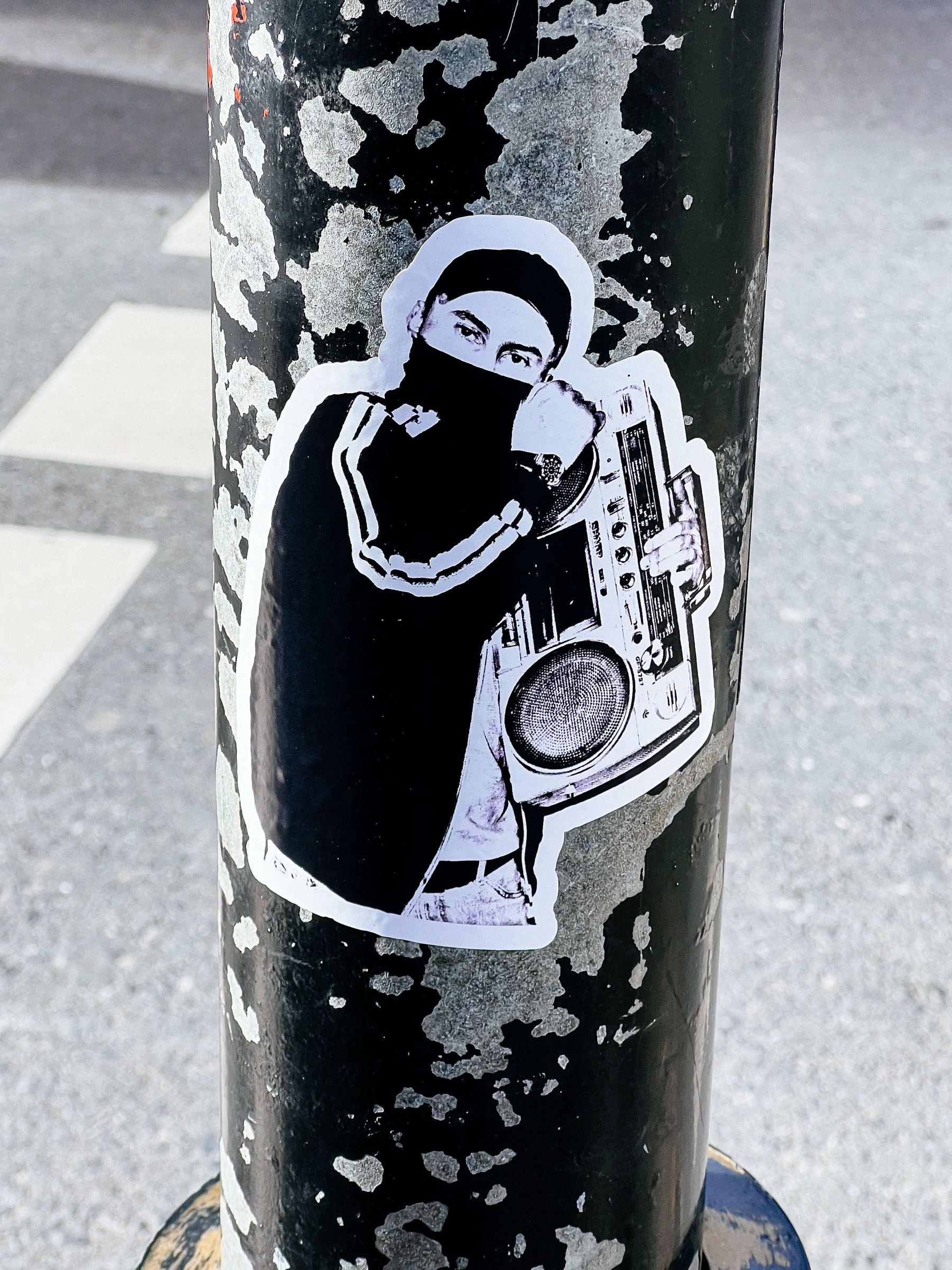 A young man holding a boombox, in a sticker. 