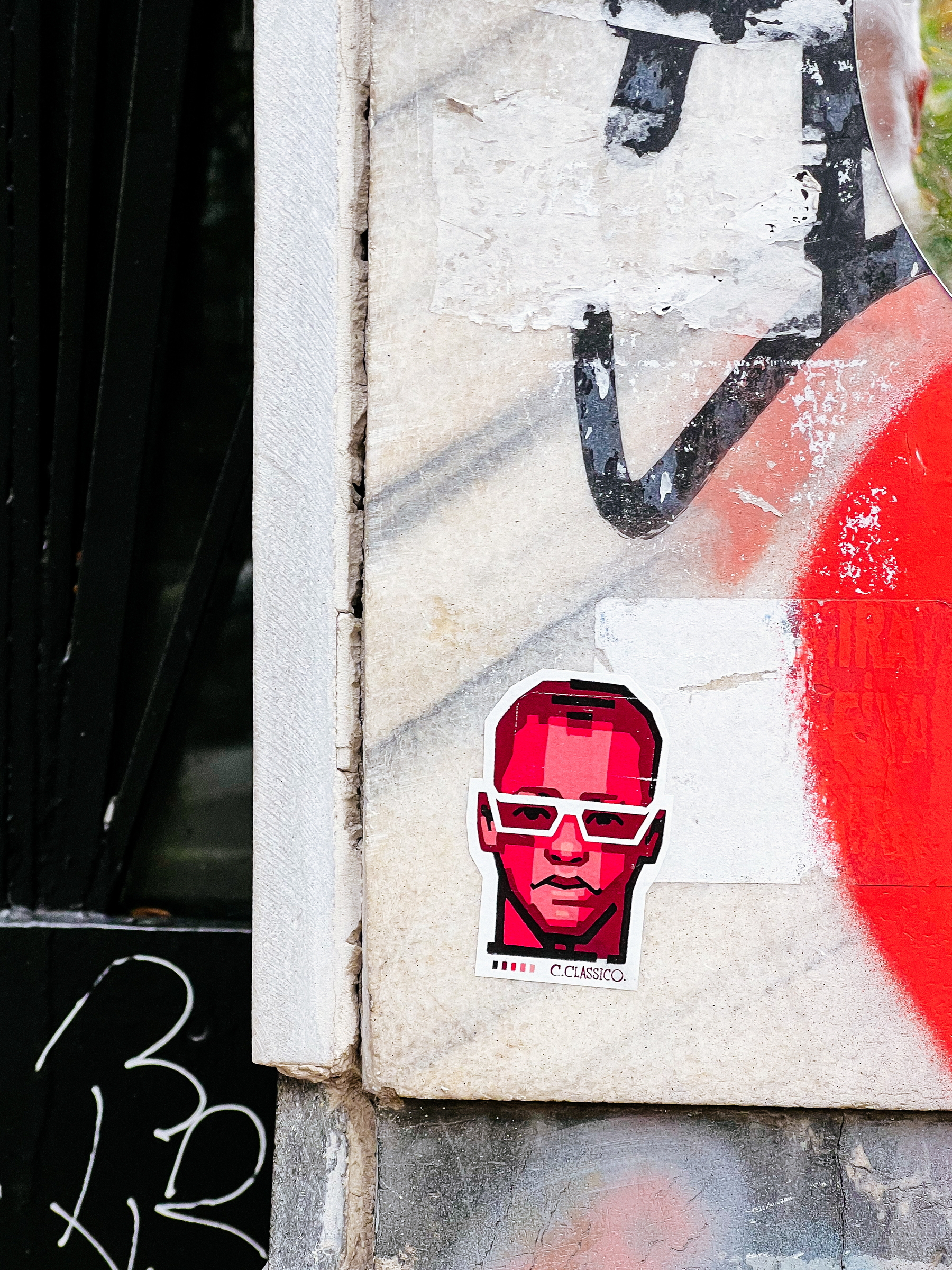 Red face. White shades. A sticker. 