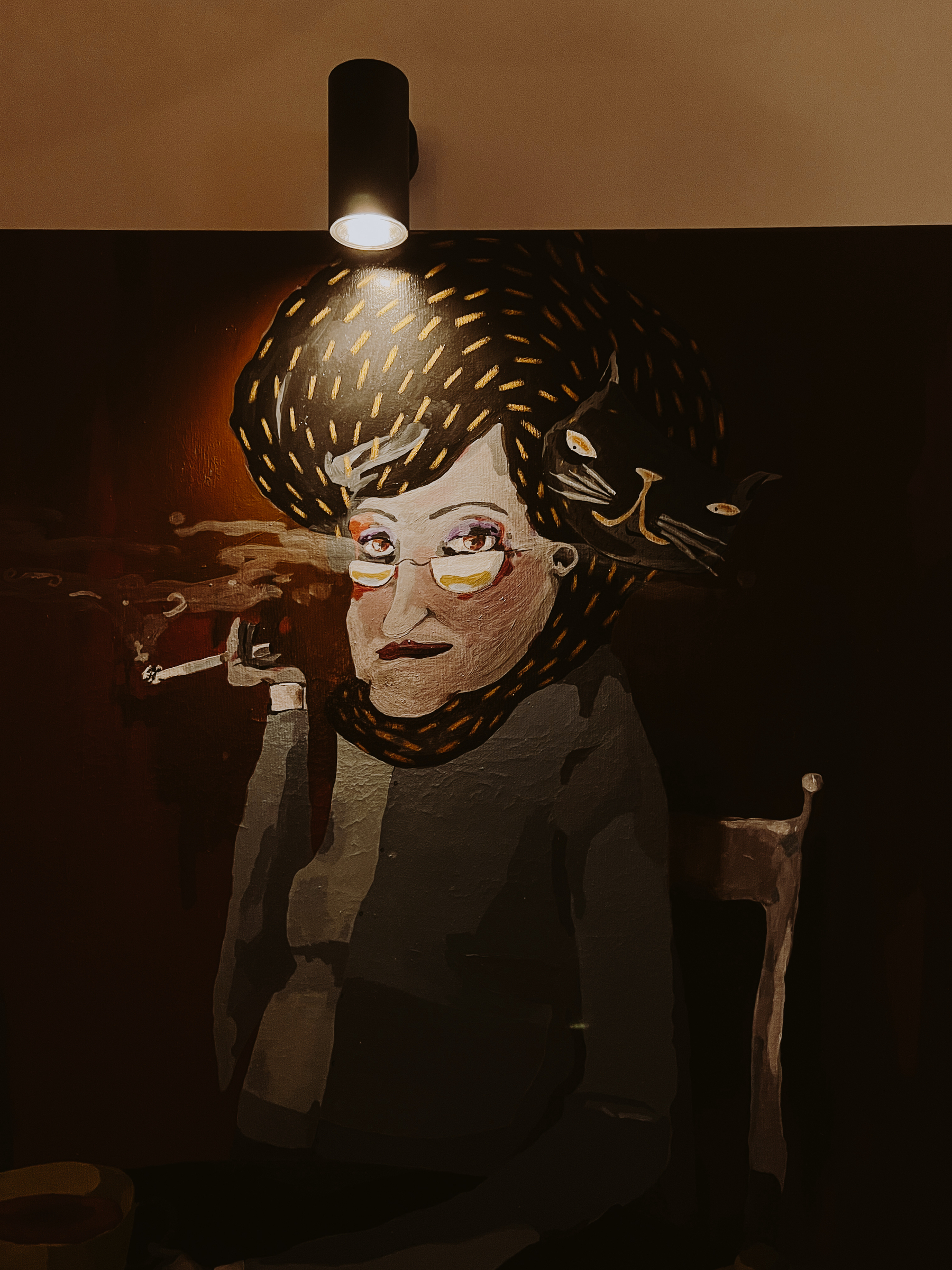 Painting of a woman with glasses smoking a cigarette, under a spotlight, with a stylized cat in her hair.