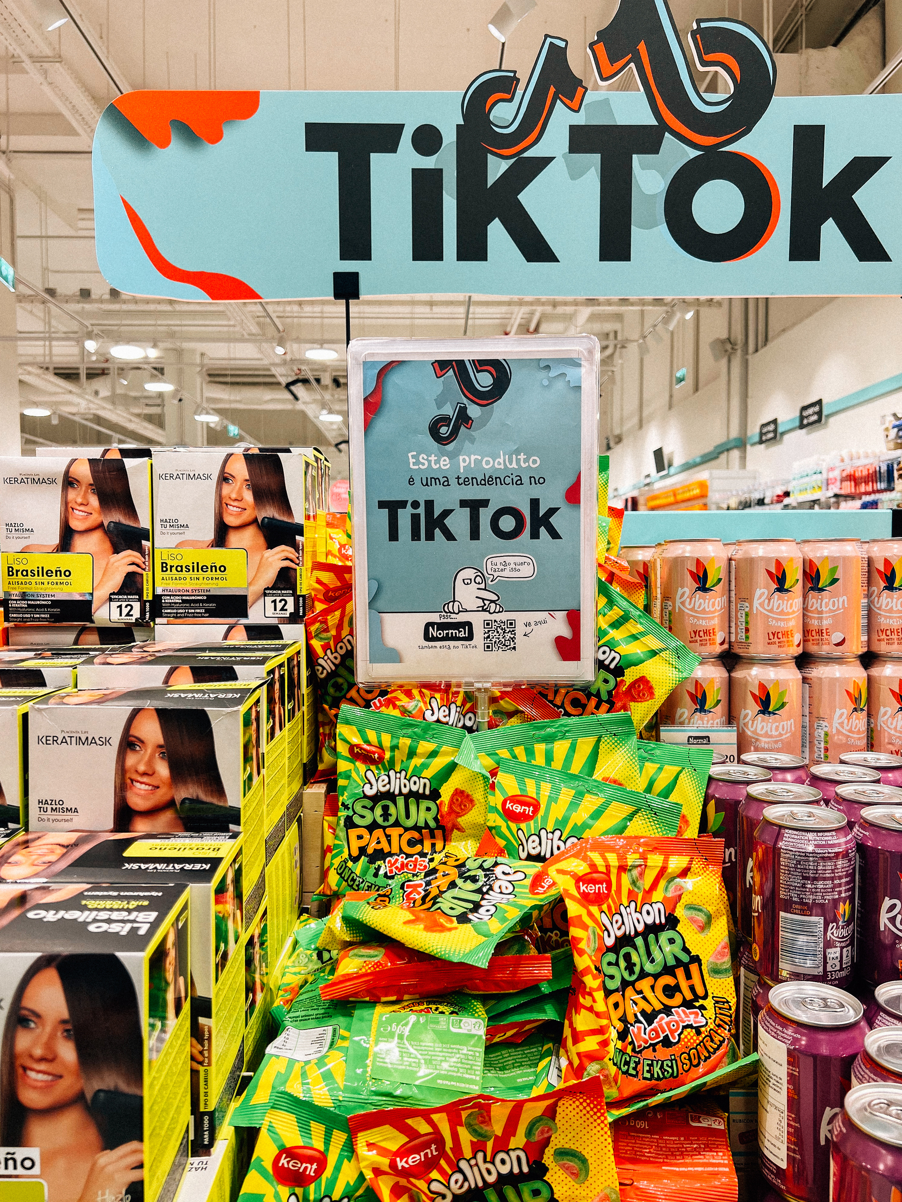 A display in a store featuring a variety of products, including hair care boxes and Sour Patch Kids candy, with a sign overhead reading &ldquo;TikTok&rdquo; suggesting these items are popular or trending on the TikTok platform.