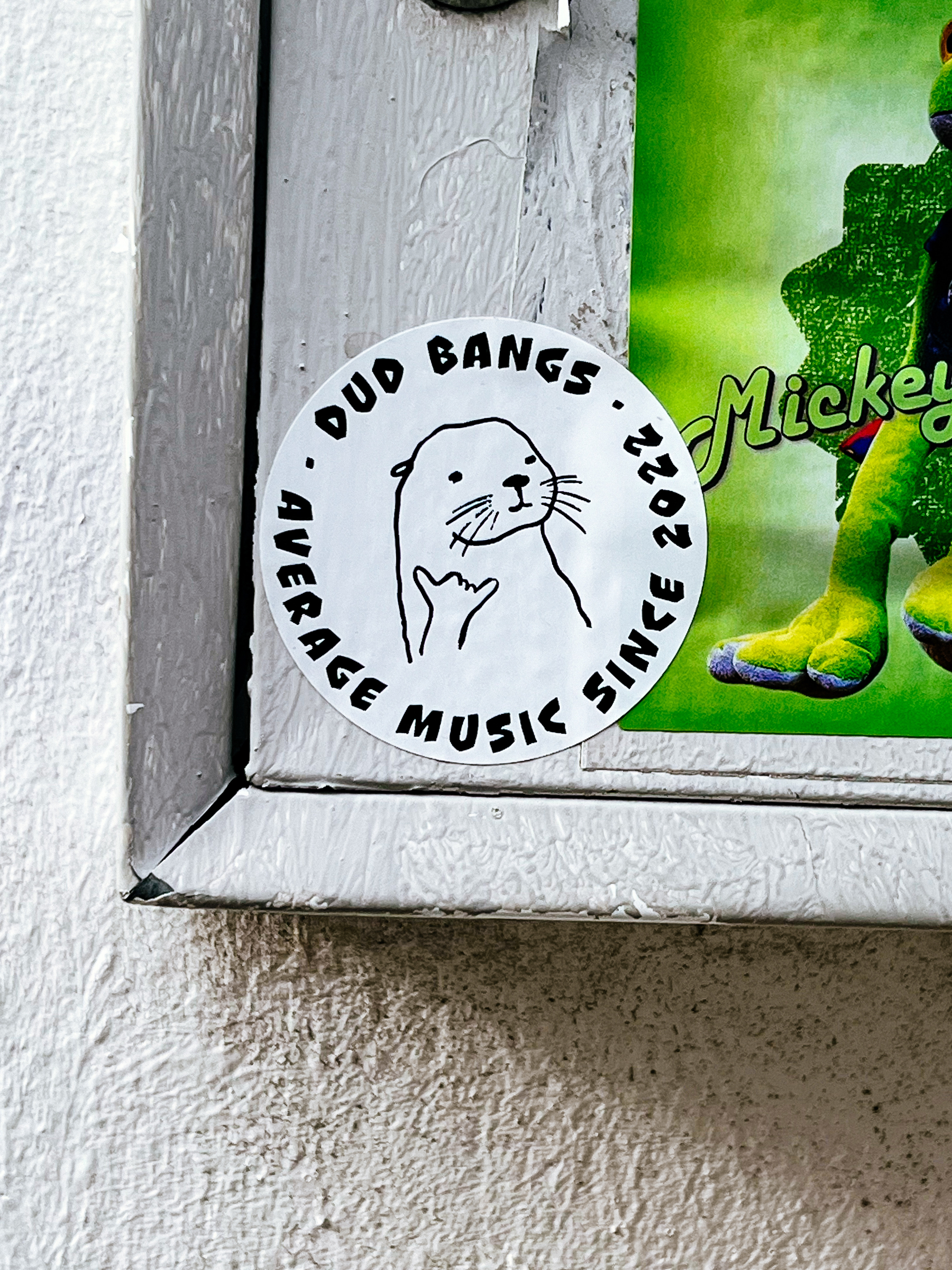 An otter (?), and “dud bangs, average music since 2022”. A sticker. 