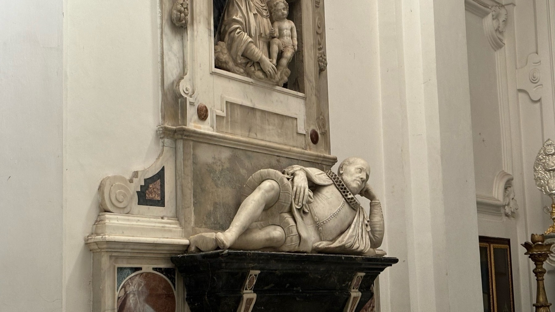 A statue of a man lounging in a side chapel within the church of St Stephen Protomartyr in Capri, Italy. 