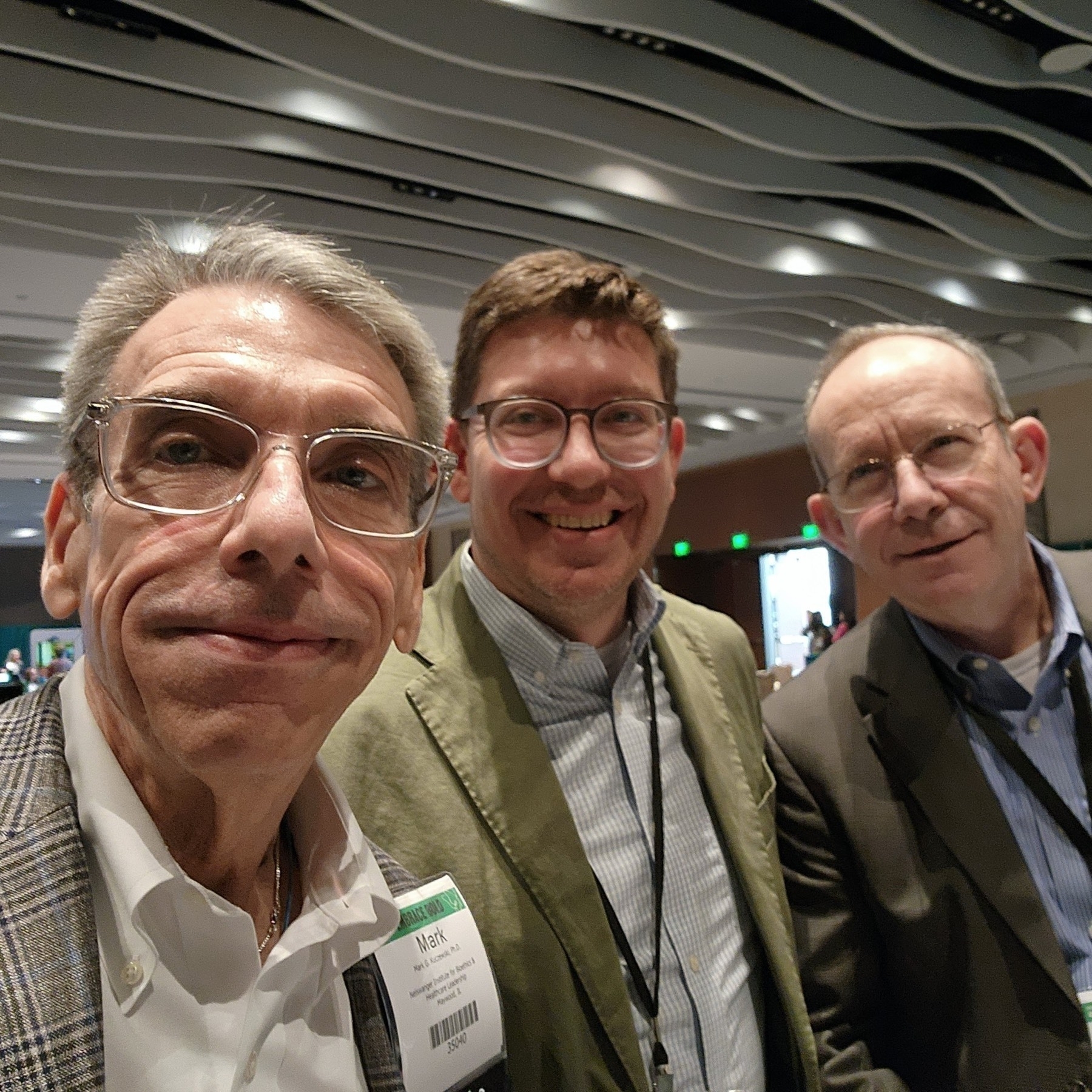 Some of my favorite colleagues (Mark & Patrick) and I in the exhibit hall at the 2024 Catholic Health Assembly. Photo by [@BioethxMark@mstdn.social](https://micro.blog/BioethxMark@mstdn.social)