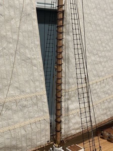 Close up of mast hoops on main sail on Bluenose model
