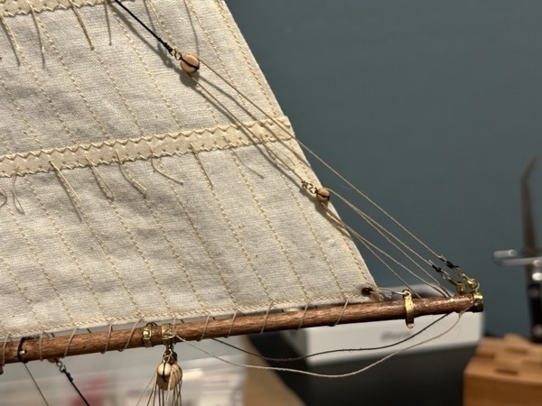 Close up of topping lift and tackle on Bluenose model ship. 