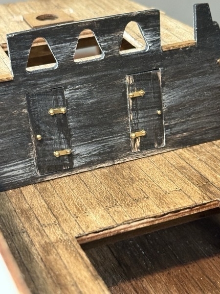 2 small black doors on the fore of the flying dutchman model ship. 