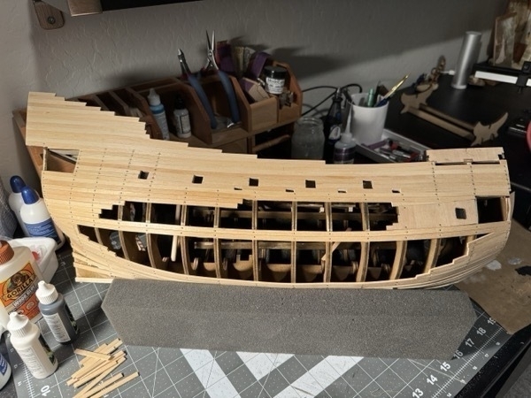 view of the starboard side of the flying dutchman model ship with most of the planking completed - shows the big gaping hole that is supposed to be on that side. 