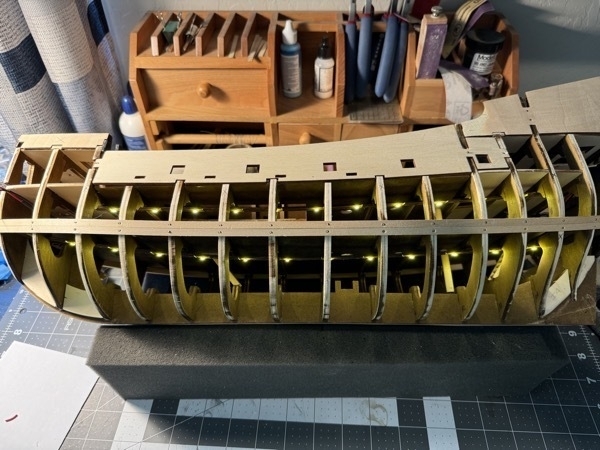 View of port side of flying dutchman model ship showing the LED lighting installed on the lower deck and in the hold.