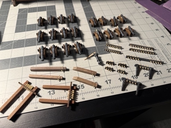 Array of small and large cannons, various belaying pin rails and some other posts and things for the flying dutchman model ship