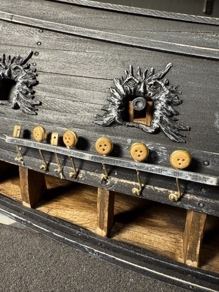 Close up view of the deadeyes and blocks attached to the hull of the flying dutchman nodel ship. 