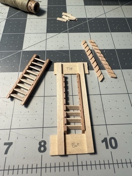 Image of a ladder and the jig used to build them with another ladder in progress inside the jig. 