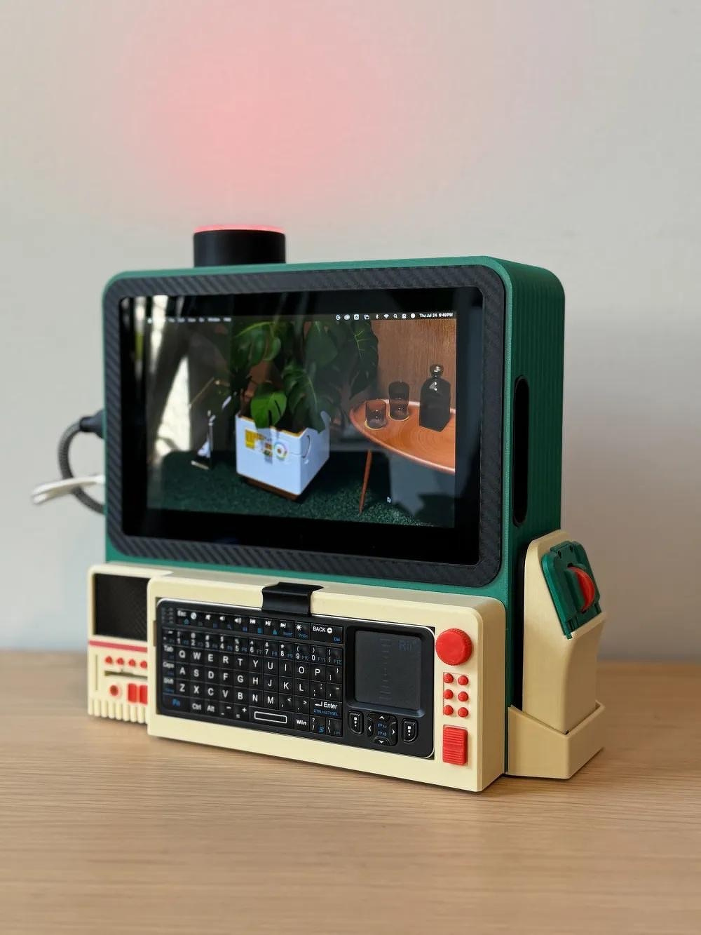 A compact, retro-styled computer device with a small screen displaying a plant and table scene, accompanied by a built-in keyboard and control buttons, is placed on a wooden surface.
u/3DBROOKLYN's Made my first cyberdeck