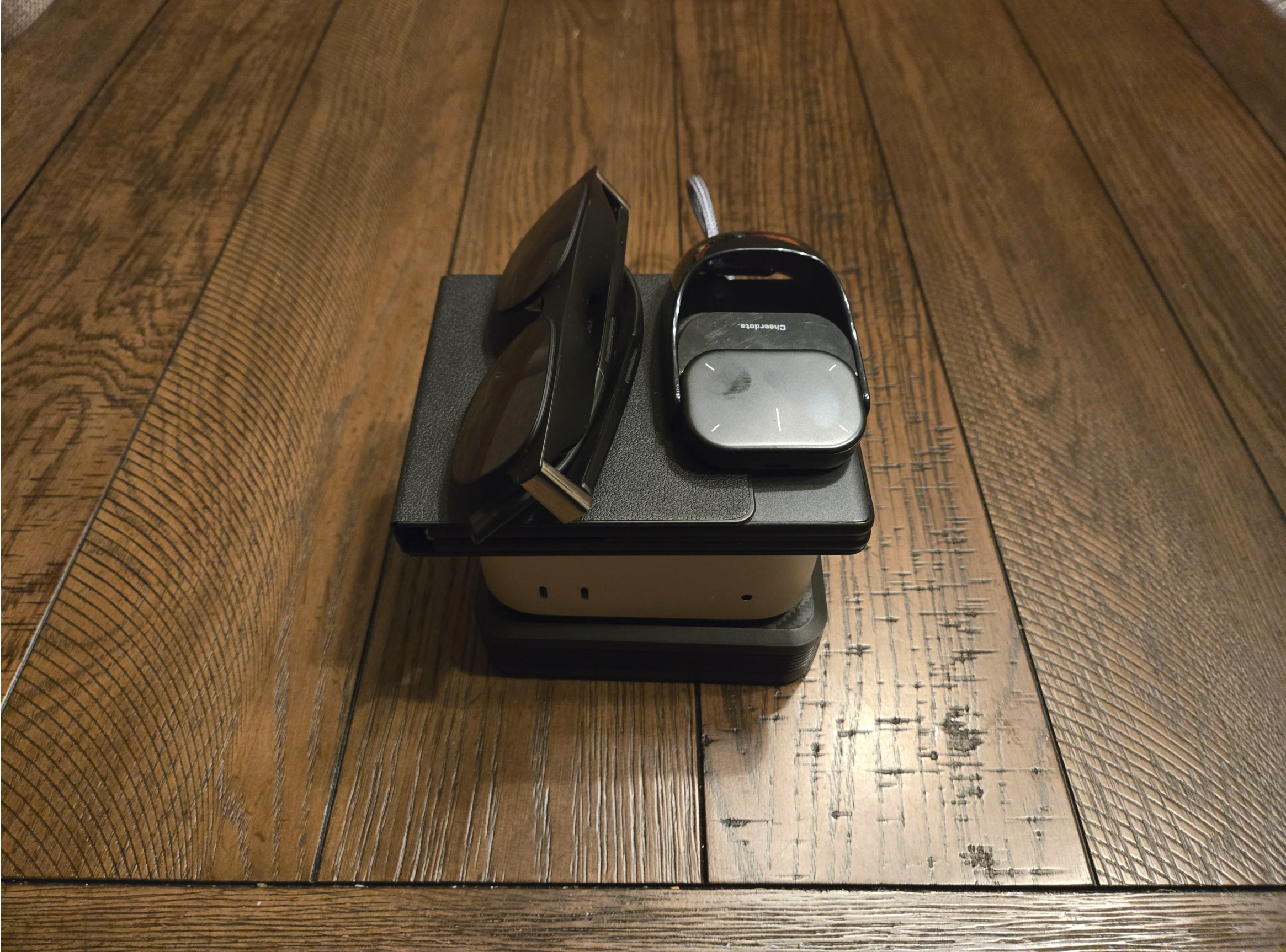 A pair of sunglasses, a car key fob, and some stacked electronic devices are placed on a wooden surface.
u/harrybootoo's Portable Mac Mini + Xreal One Pro