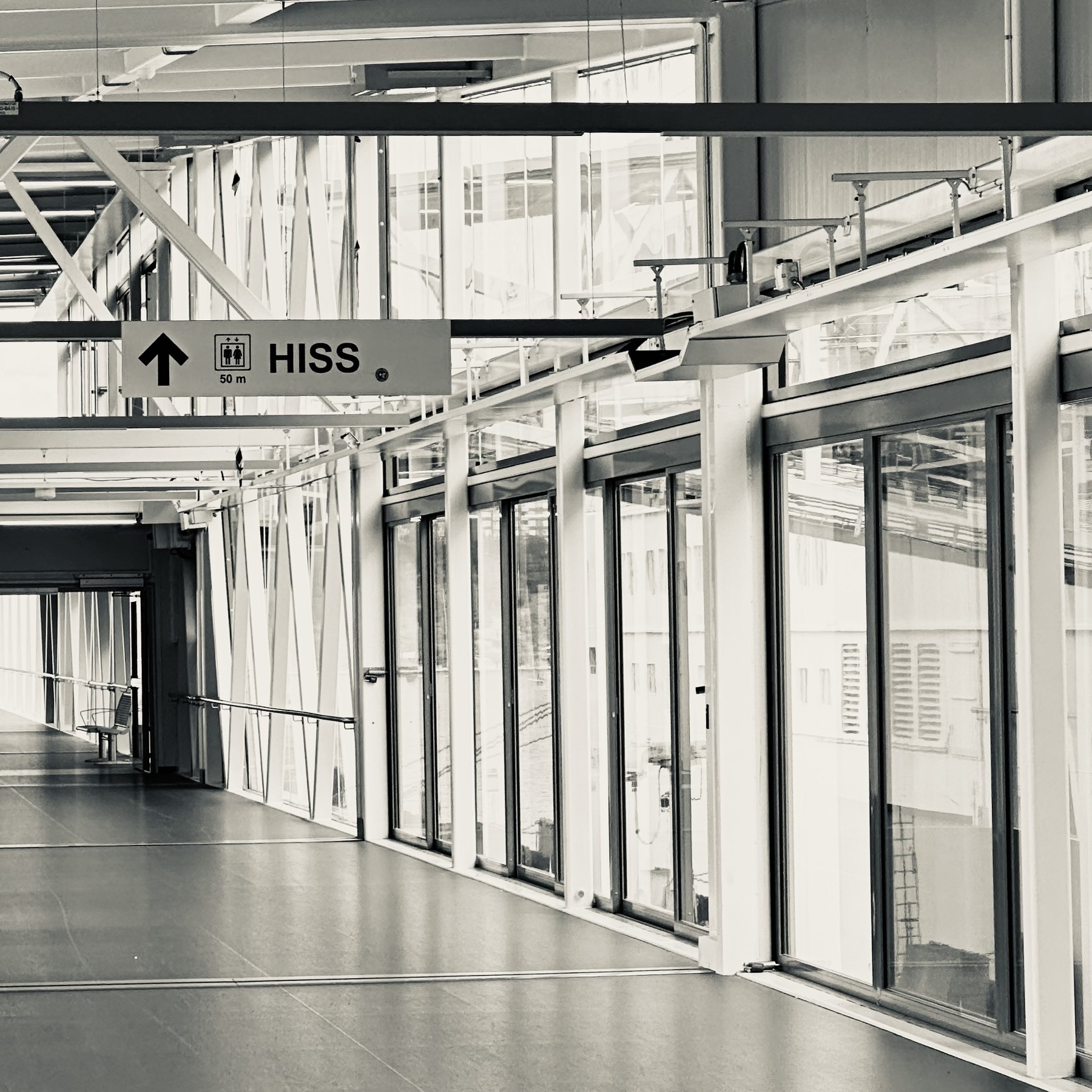 An empty corridor with a sign that says “HISS”.
