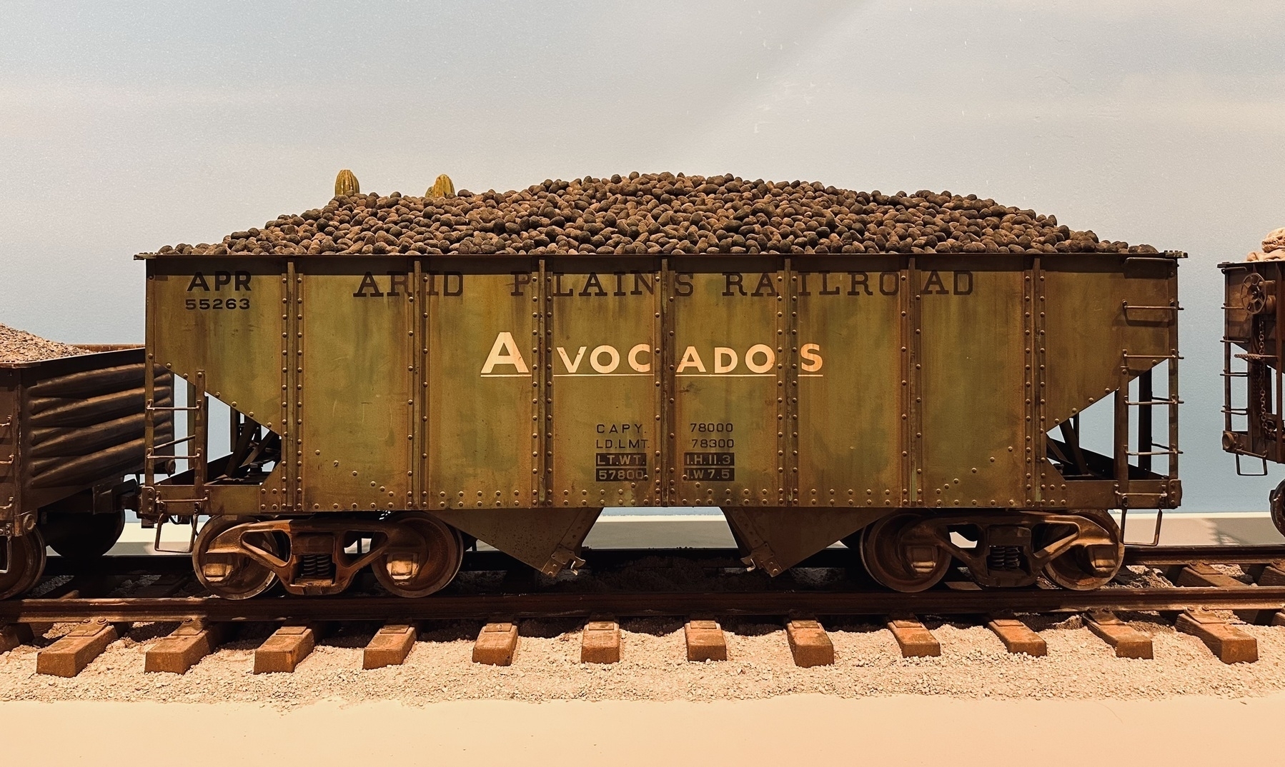 A model train wagon carrying avocados. Owned by the fictional Arid Plains Railroad.