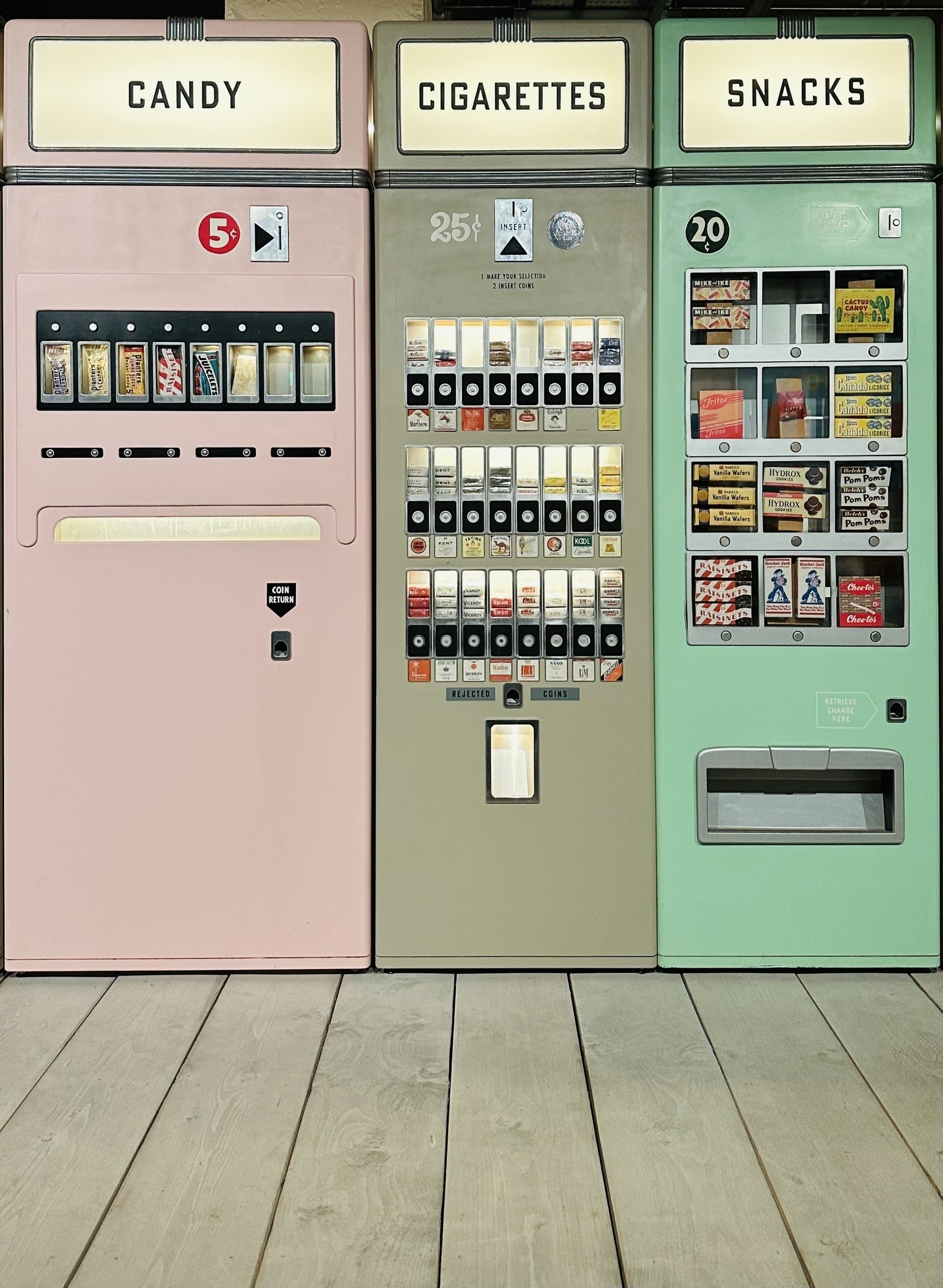 Colourful 50s style vending machines selling candy, cigarettes, and snacks. From the film Asteroid City.