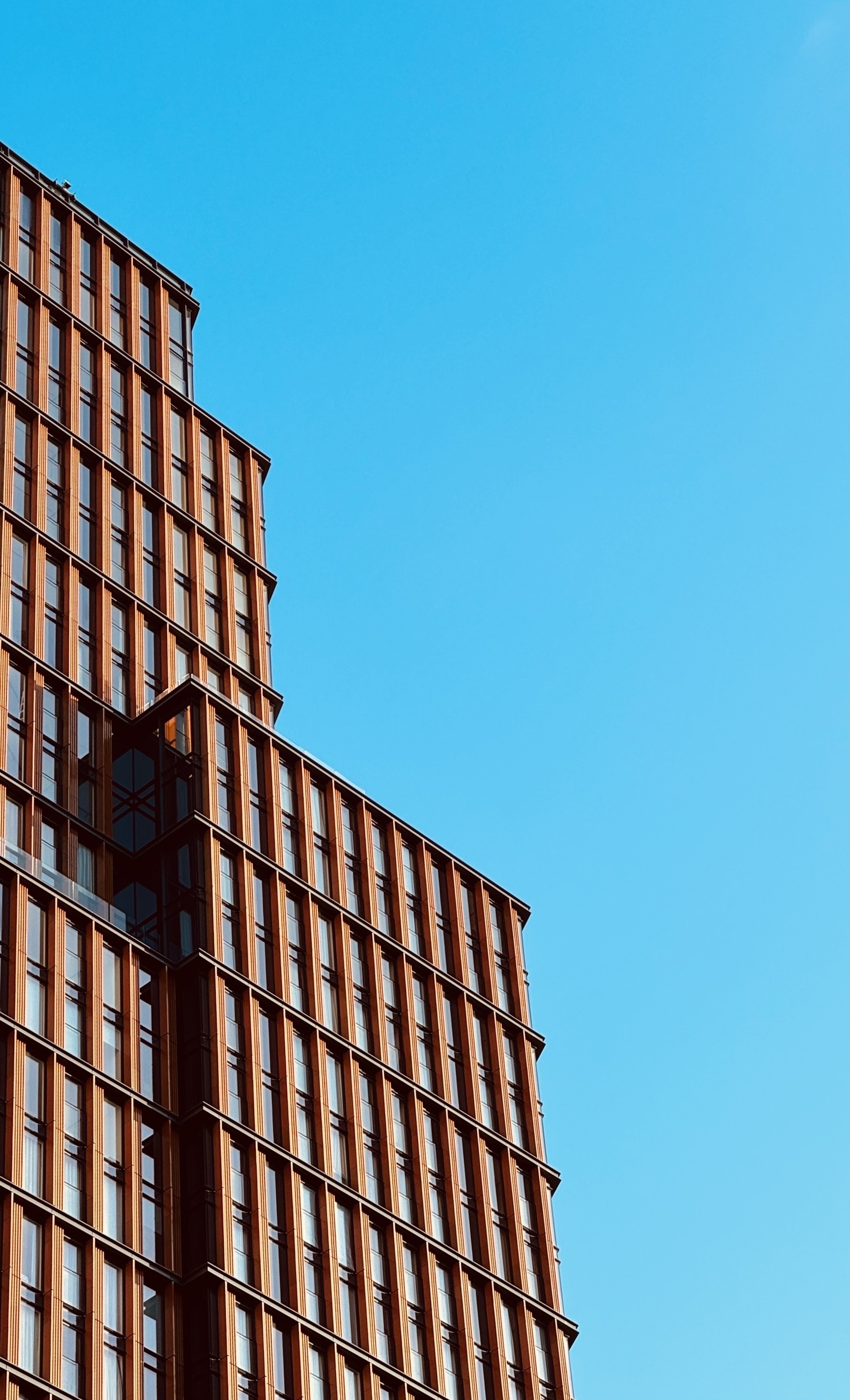 A copper clad building against the bright blue sky.