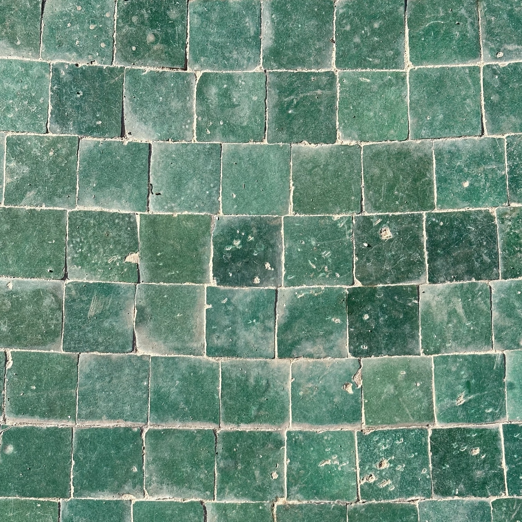 A square photo of square green tiles.