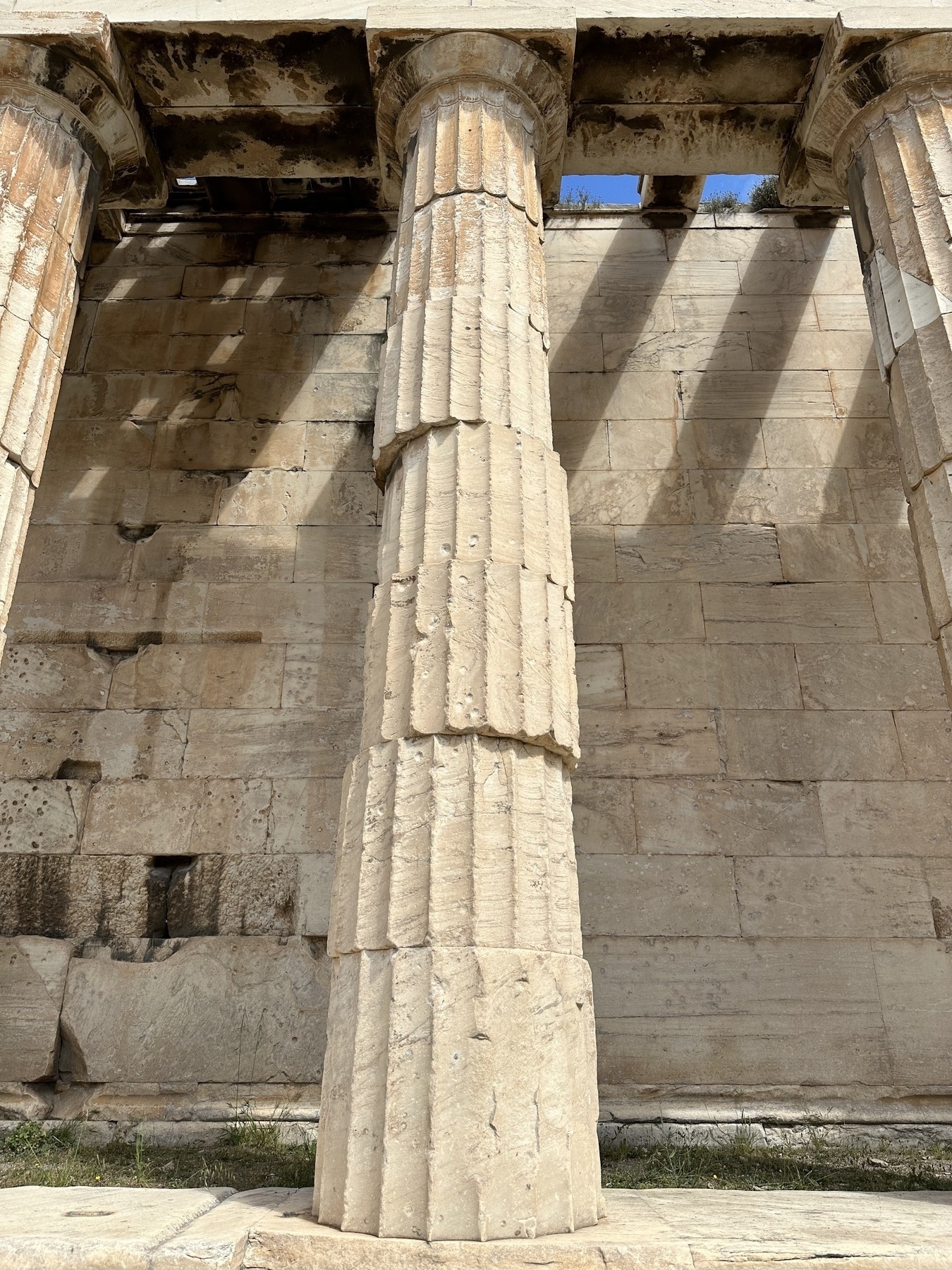 A Doric column made up of seven sections, each offset horizontally from each other, making it look slightly unstable.