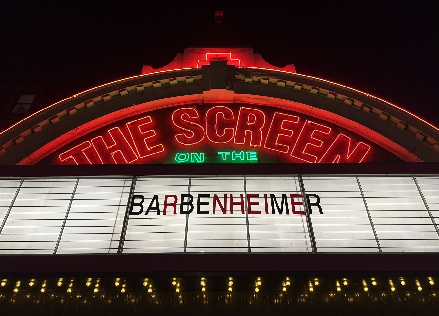 Neon signage at the Screen on the Green cinema, with BARBENHEIMER spelt out below.
