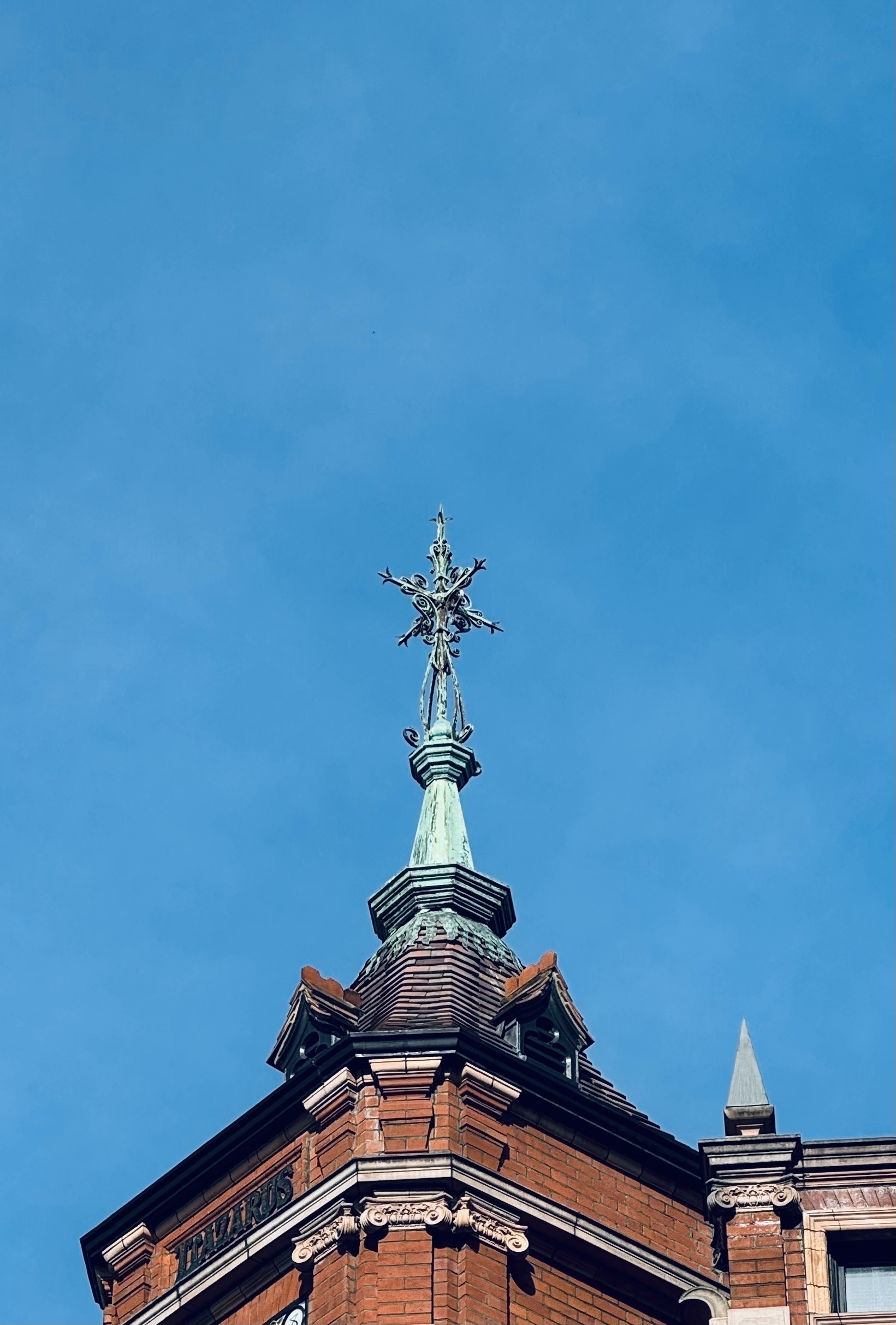 A spiky copper spire on top of a tower.