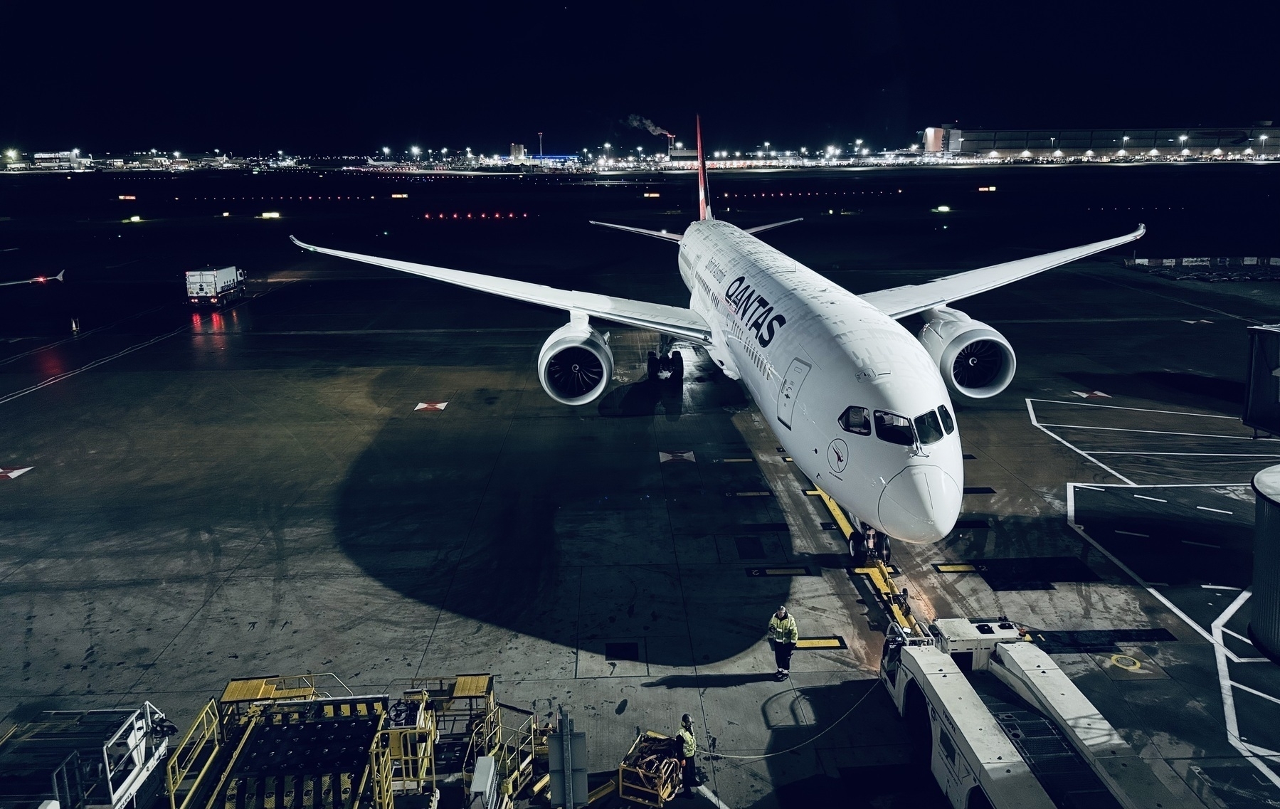 A Qantas plane in the pre-dawn darkness at Heathrow Airport.