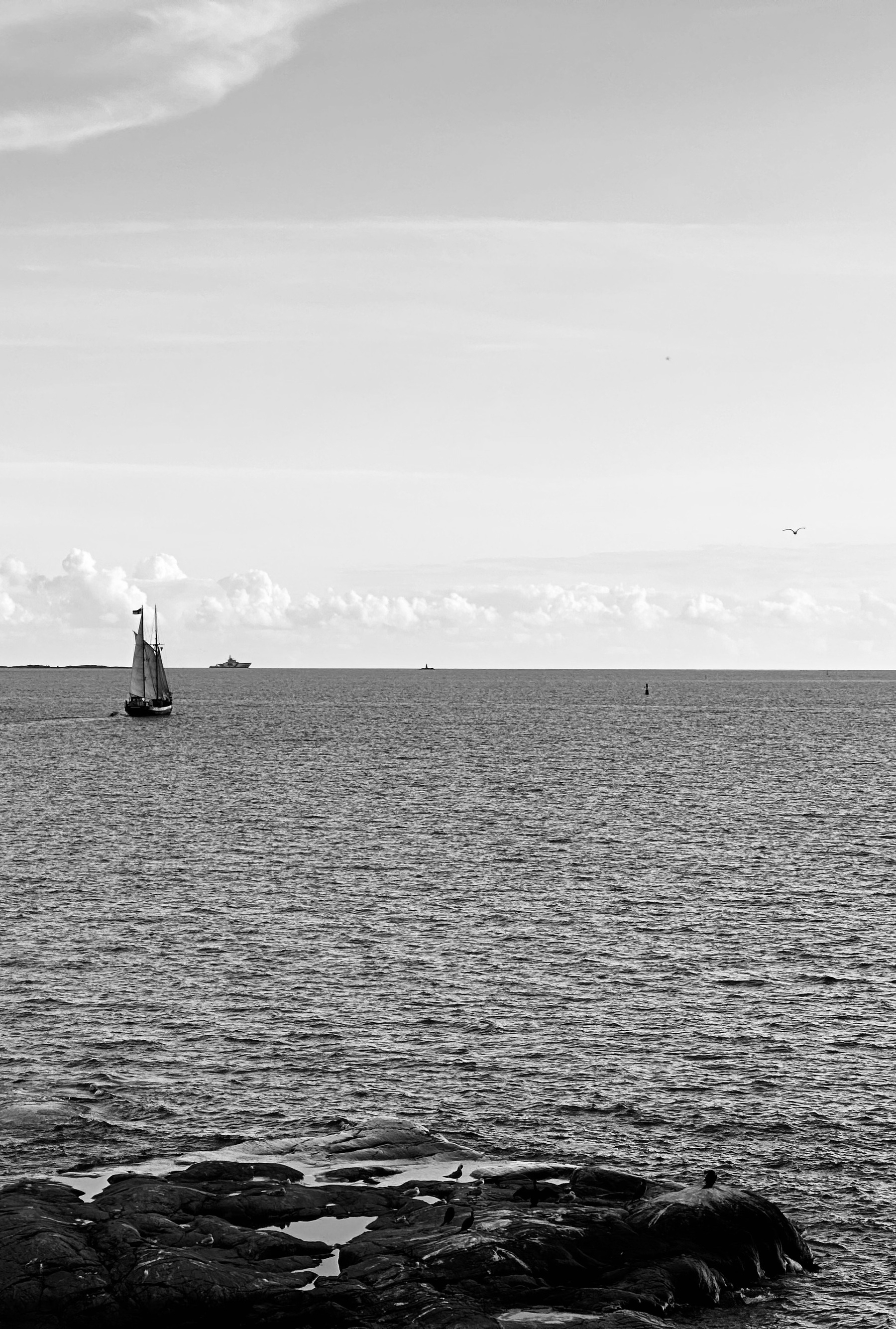 A small sailing ship on a calm sea.