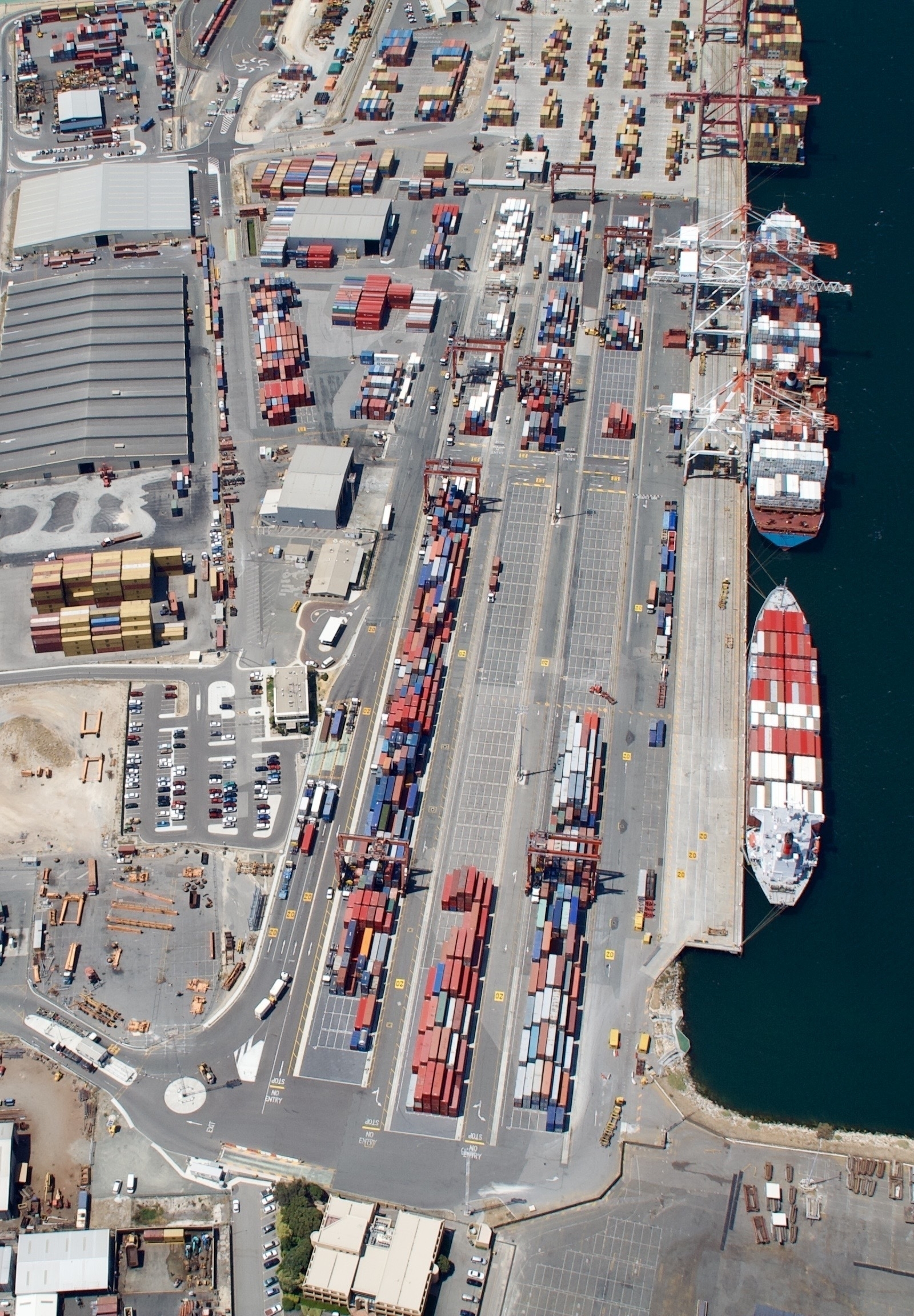 The port of Fremantle seen from the air, with lots of containers and a couple of container ships.
