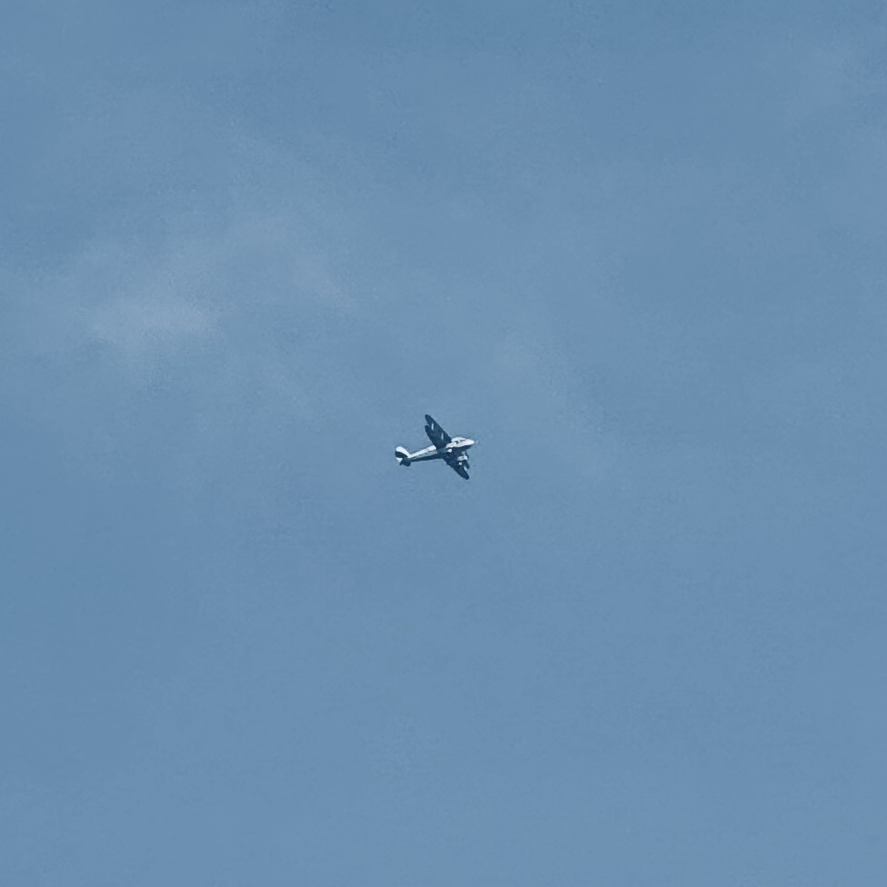 A biplane flying in clear skies.