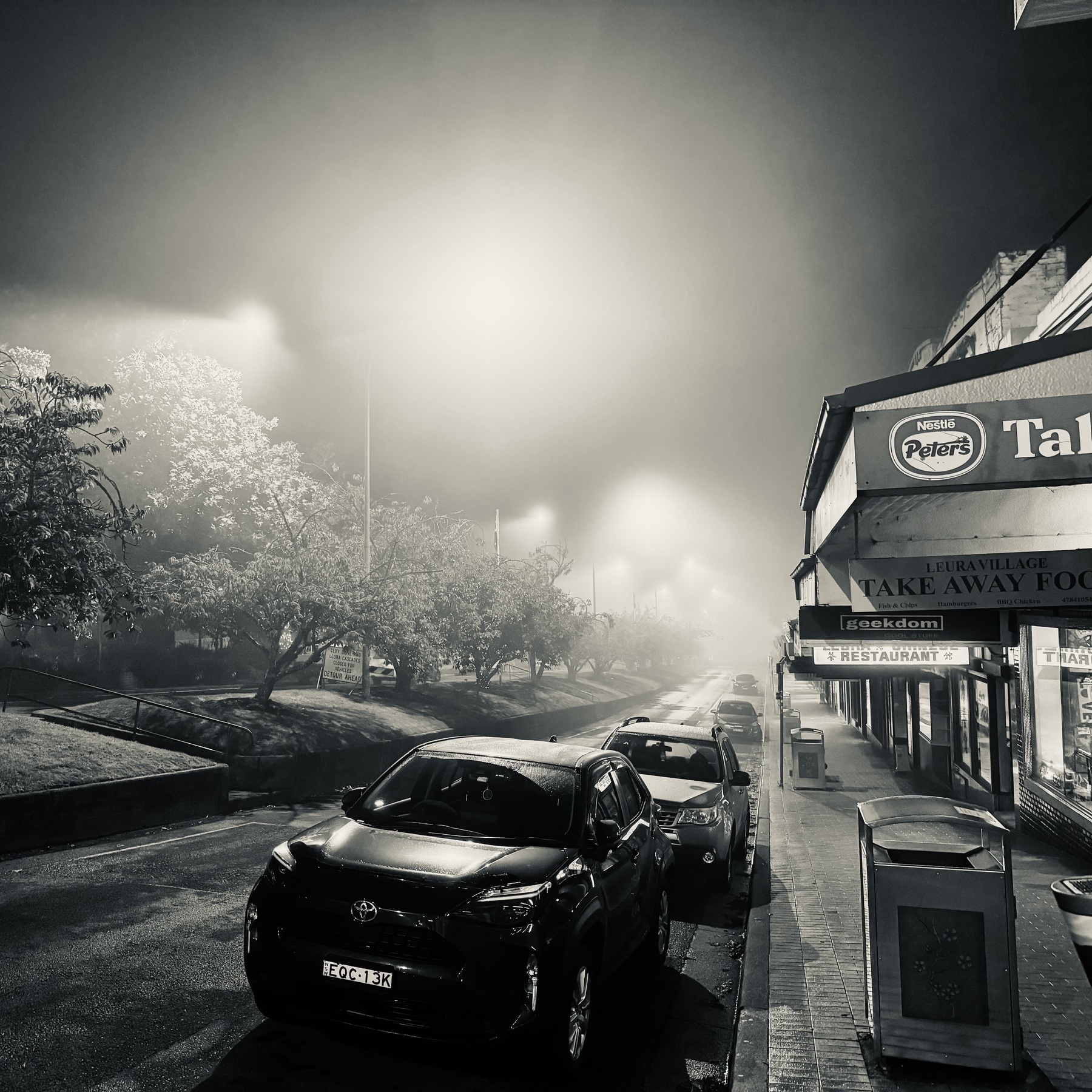 A quiet street at night, slightly misty.