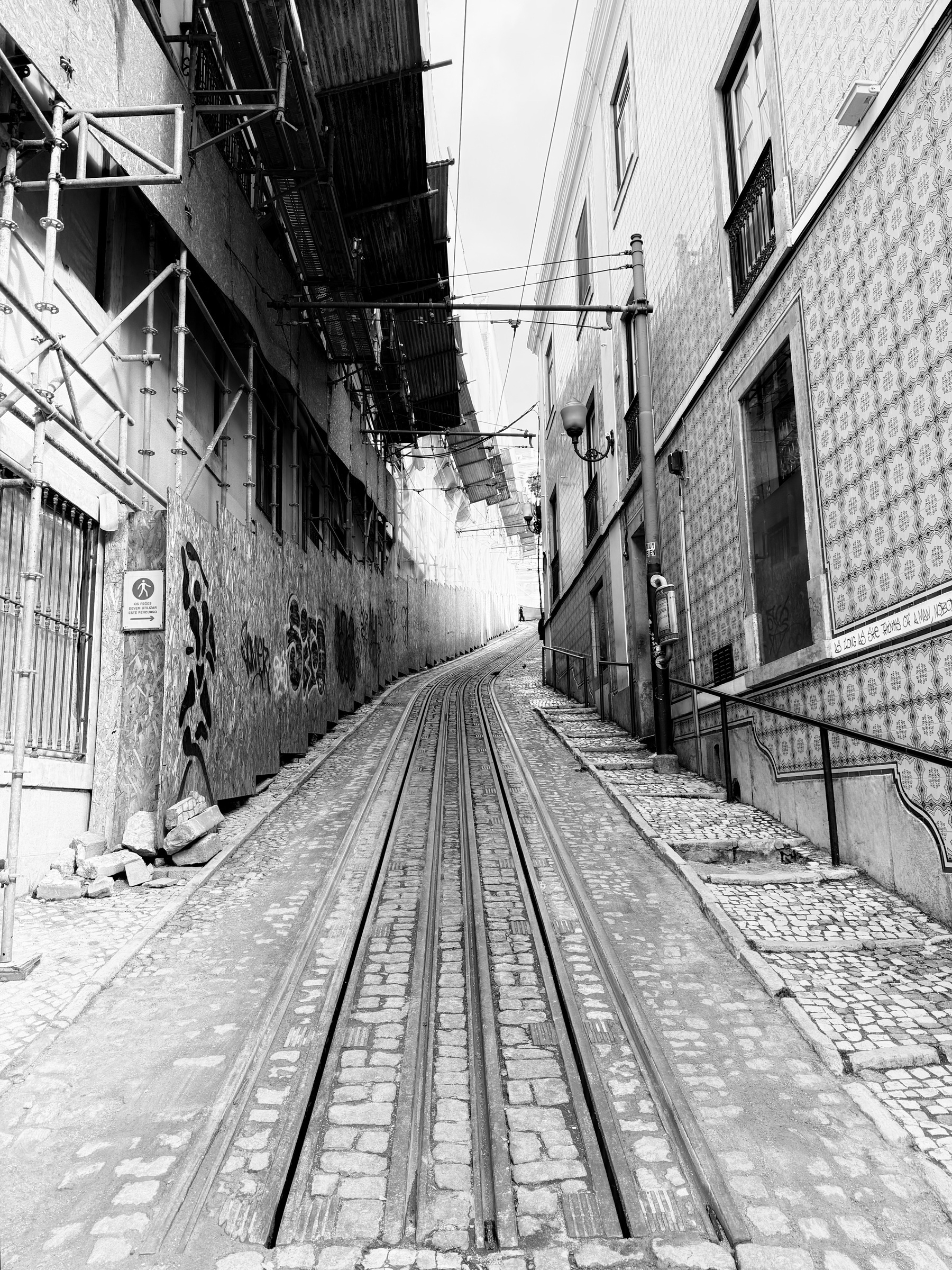 Funicular tracks heading up a narrow cobbled street.