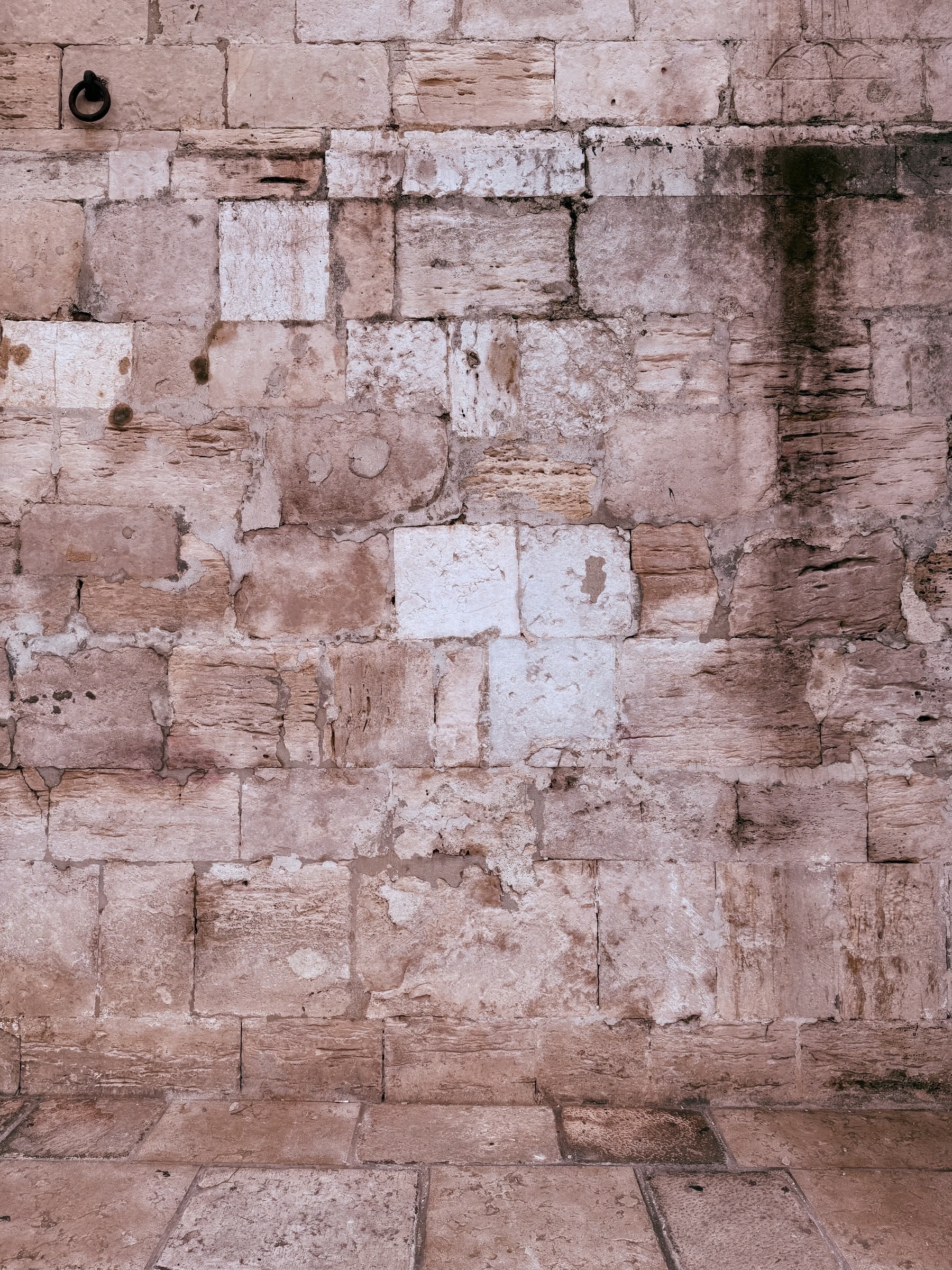 A stone wall of Lisbon Cathedral with differently sized blocks.