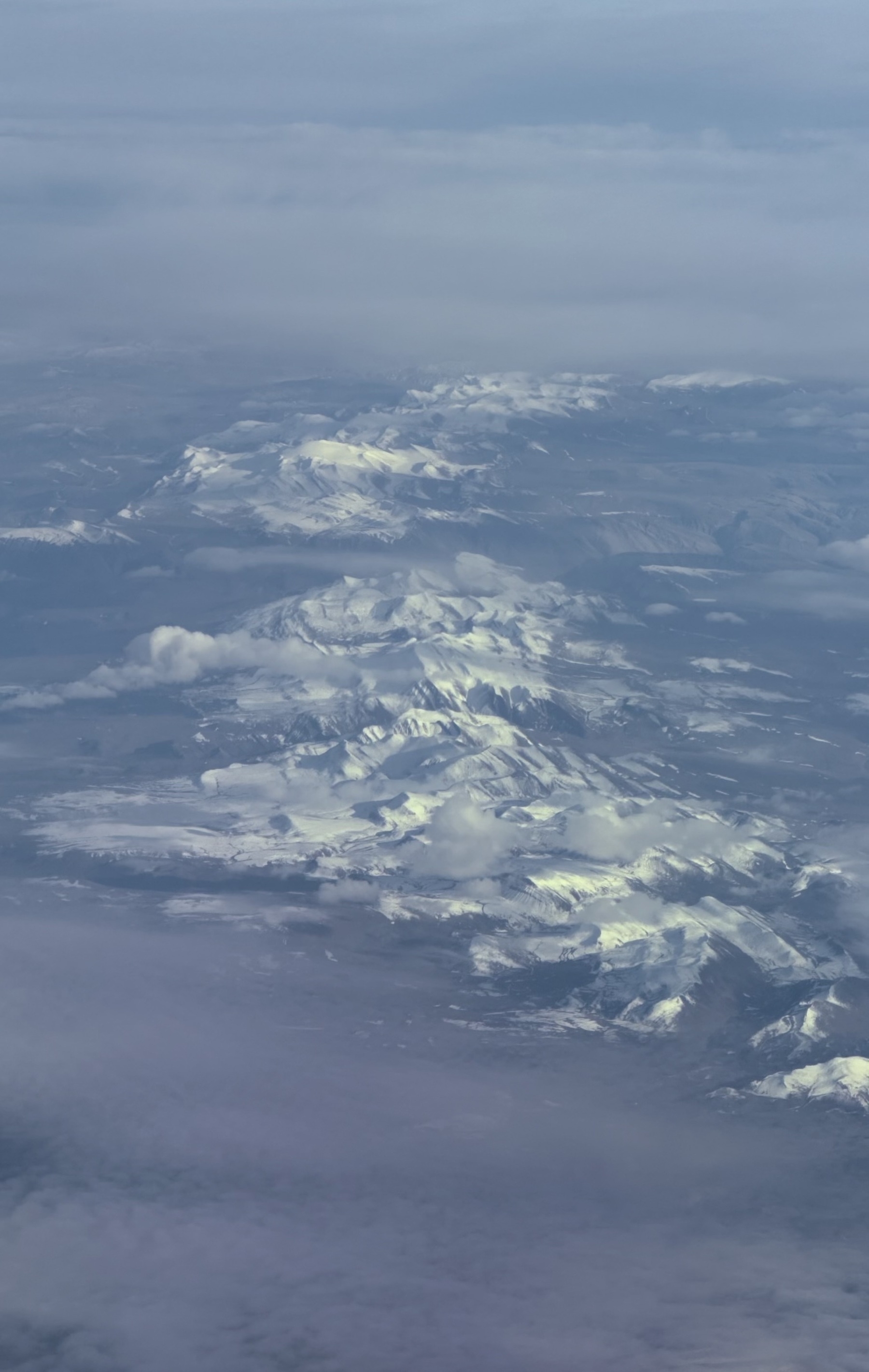 Snow capped mountains stretching in to the distance.