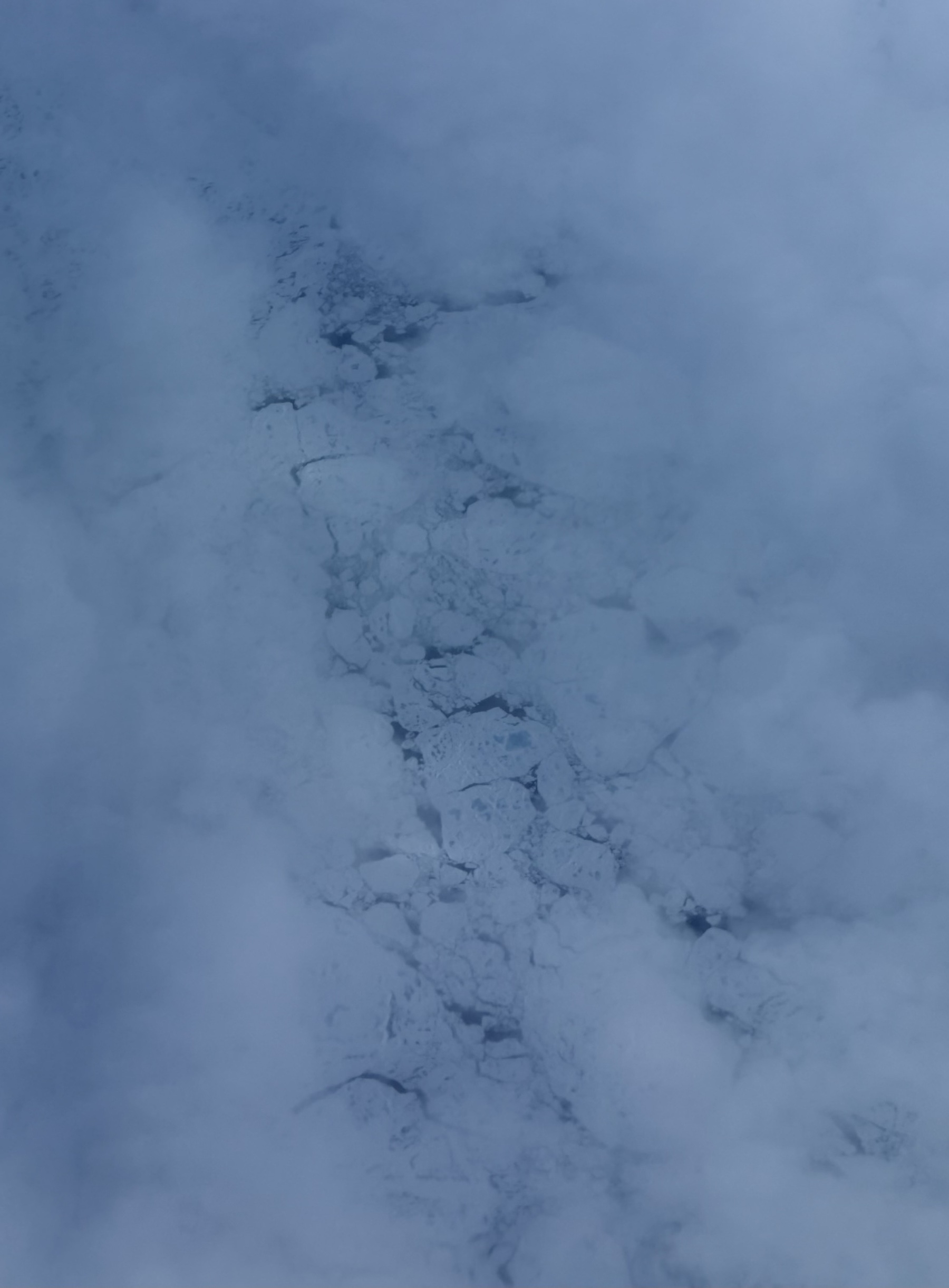 Ice in the Arctic Ocean, glimpsed through a gap in clouds.