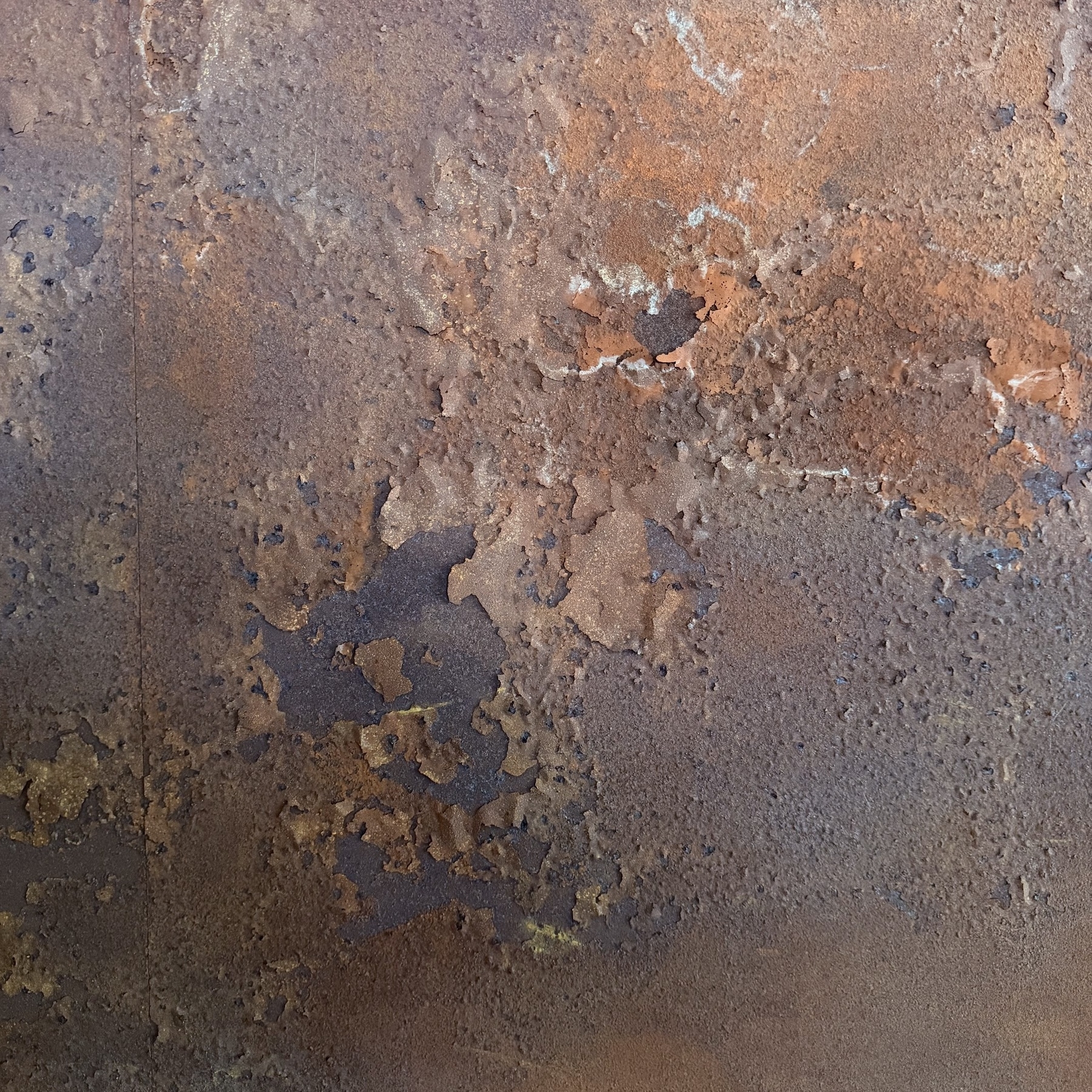 Rust flaking off a metal surface.