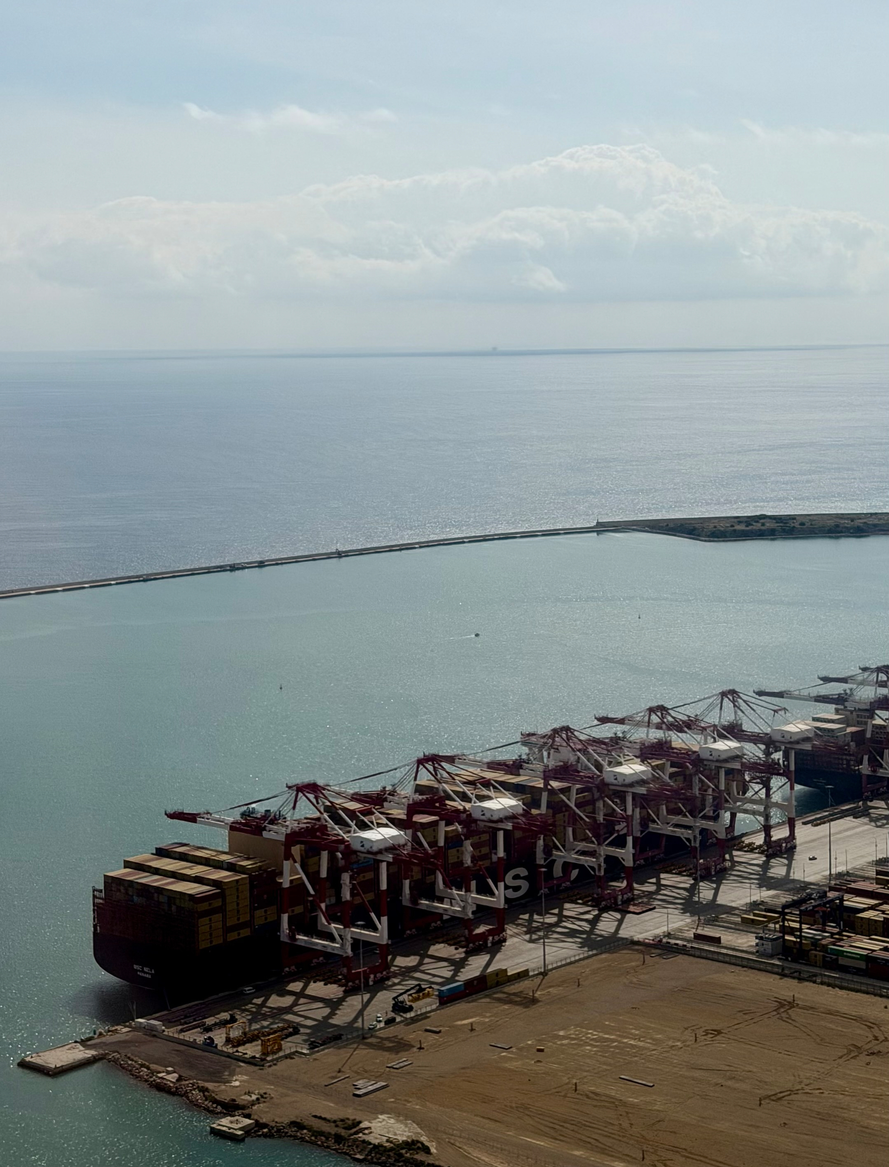 Cranes loading containers on to a ship.